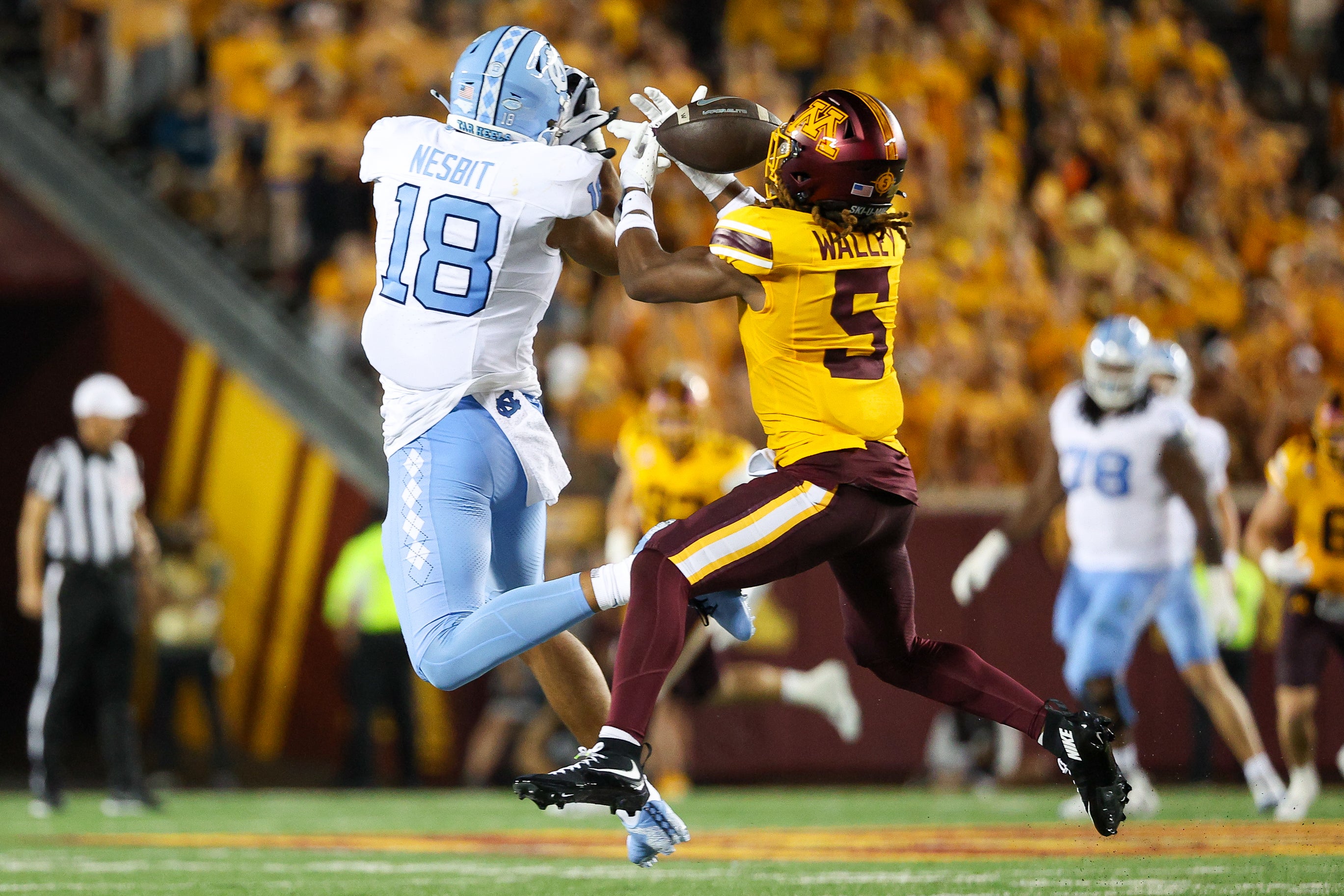 Aug 29, 2024; Minneapolis, Minnesota, USA; Minnesota Golden Gophers defensive back Justin Walley (5) intercepts a pass intended for North Carolina Tar Heels tight end Bryson Nesbit (18) during the first half at Huntington Bank Stadium.