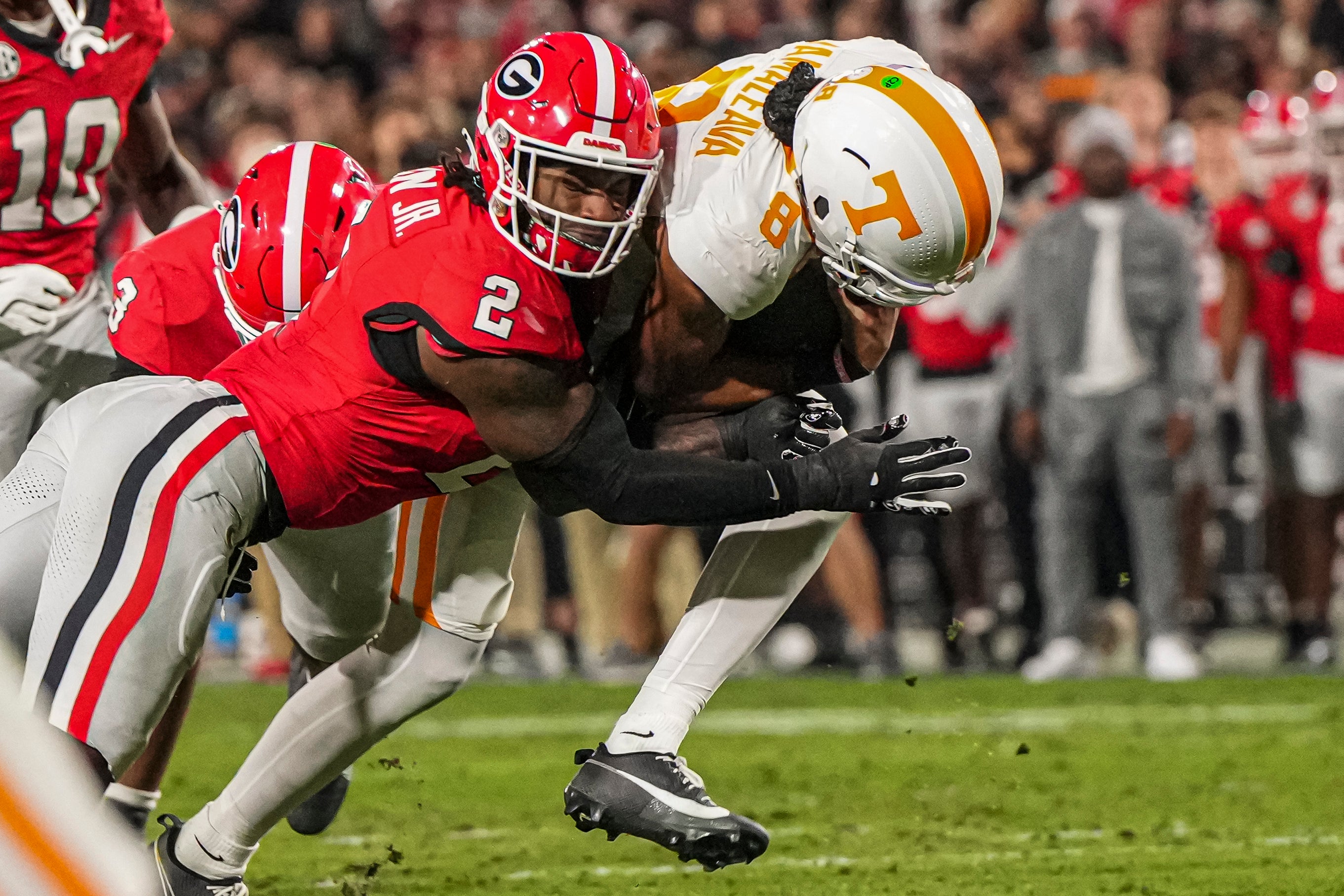 Tennessee Volunteers quarterback Nico Iamaleava (8) is tackled by Georgia Bulldogs linebacker Smael Mondon Jr. (2) during the first quarter at Sanford Stadium.
