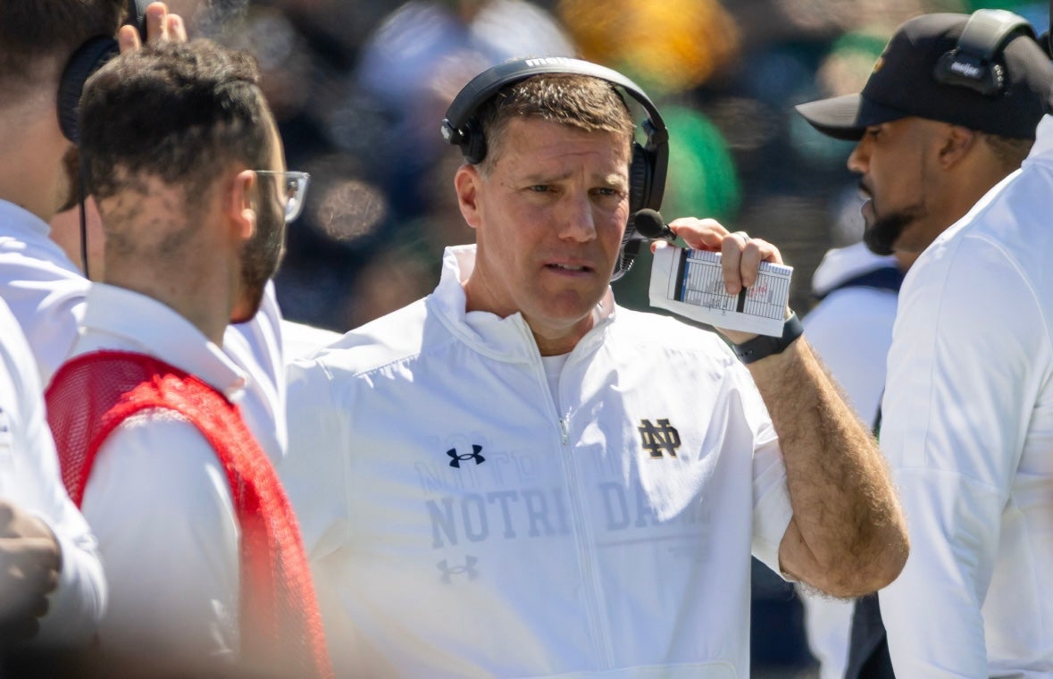 Apr 12, 2025; Notre Dame, IN, USA; Notre Dame defensive coordinator Chris Ash adjusts his headset during the Blue-Gold game at Notre Dame Stadium. Mandatory Credit: Michael Caterina-Imagn Images