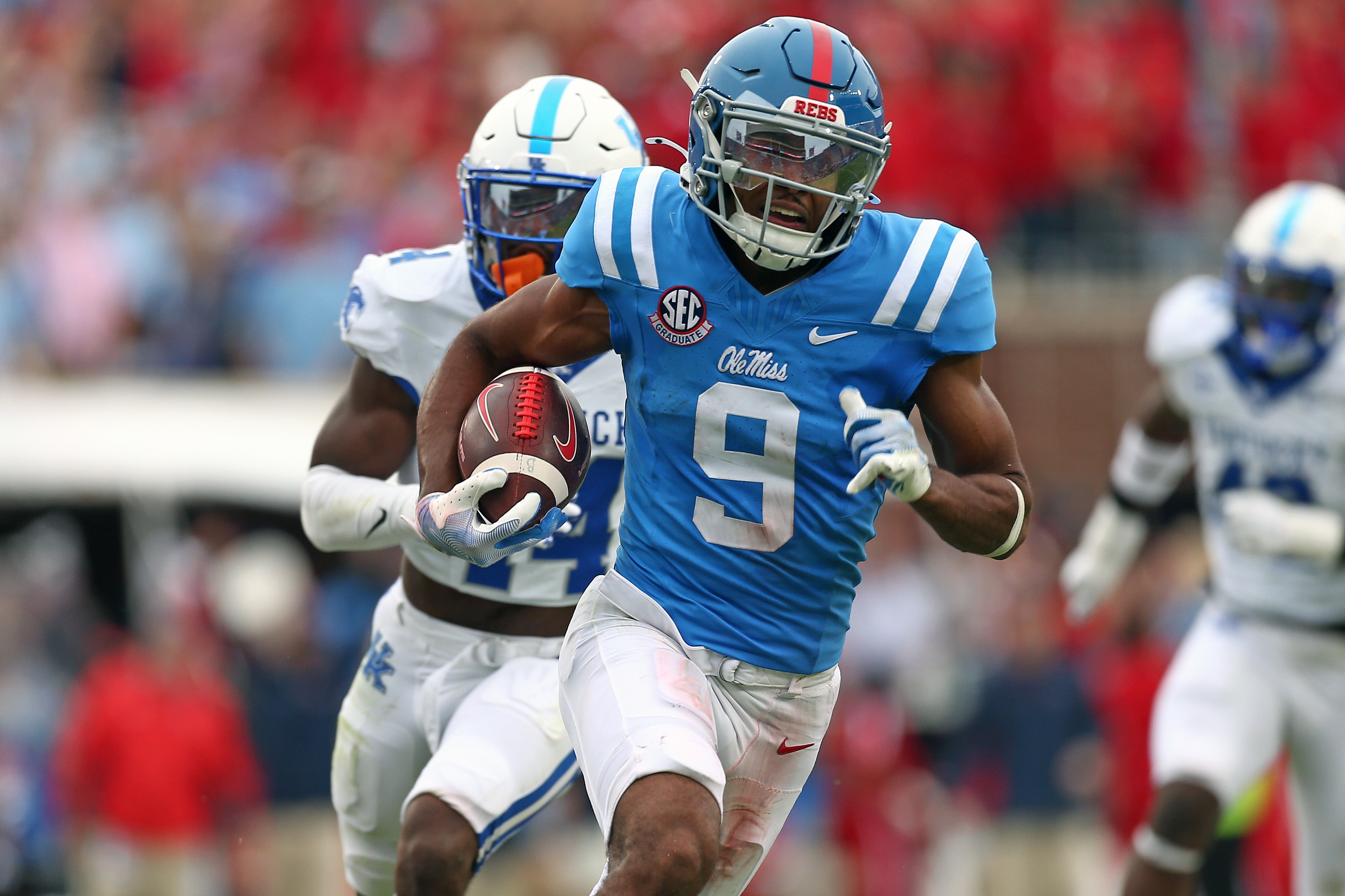 Sep 28, 2024; Oxford, Mississippi, USA; Mississippi Rebels wide receiver Tre Harris (9) runs after a catch for a first down as Kentucky Wildcats defensive back Jordan Lovett (25) pursues during the second half at Vaught-Hemingway Stadium. Mandatory Credit: Petre Thomas-Imagn Images