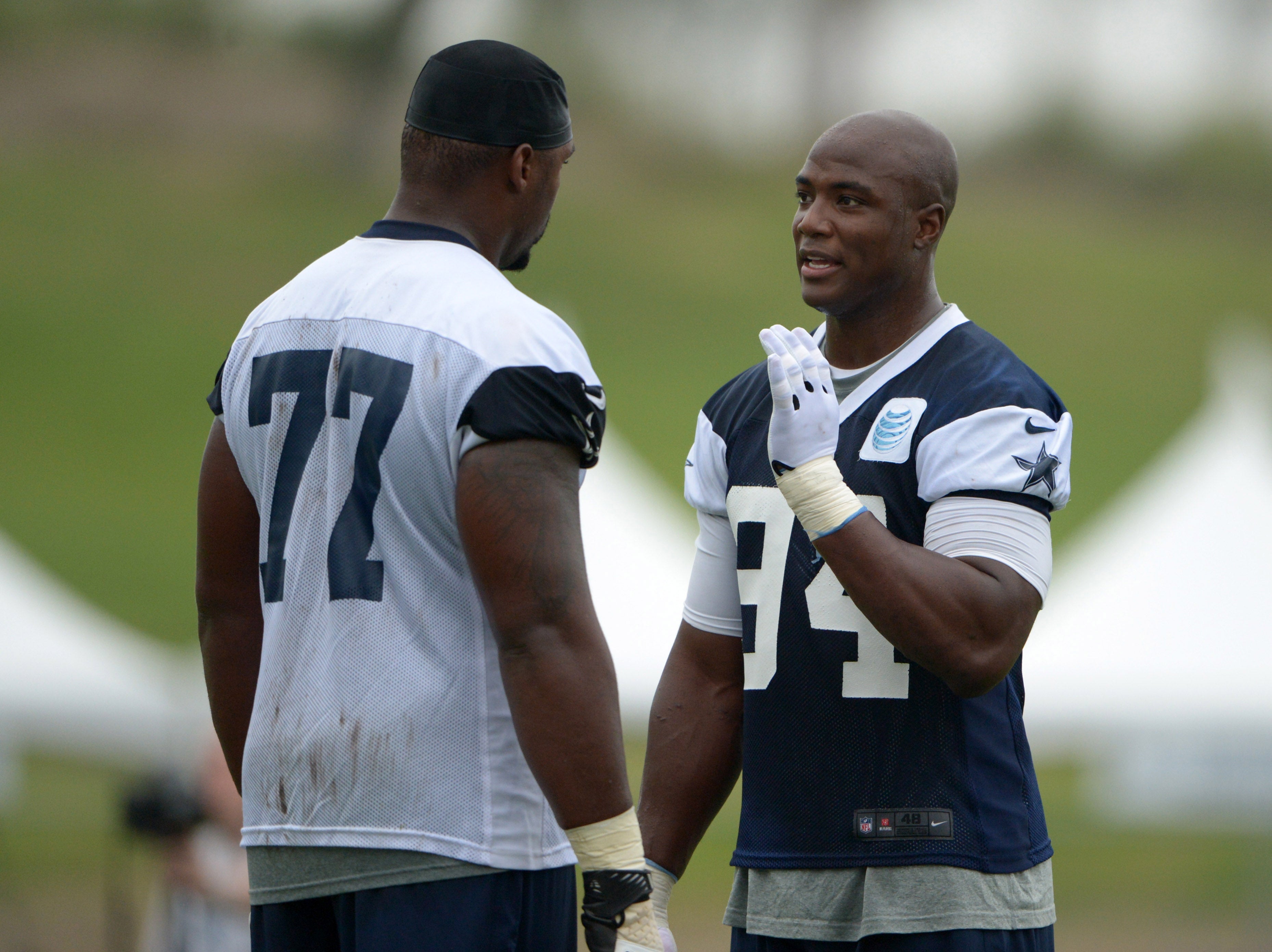 Dallas Cowboys defensive end DeMarcus Ware (94) talks with tackle Tyron Smith (77) at training camp at the River Ridge Fields.