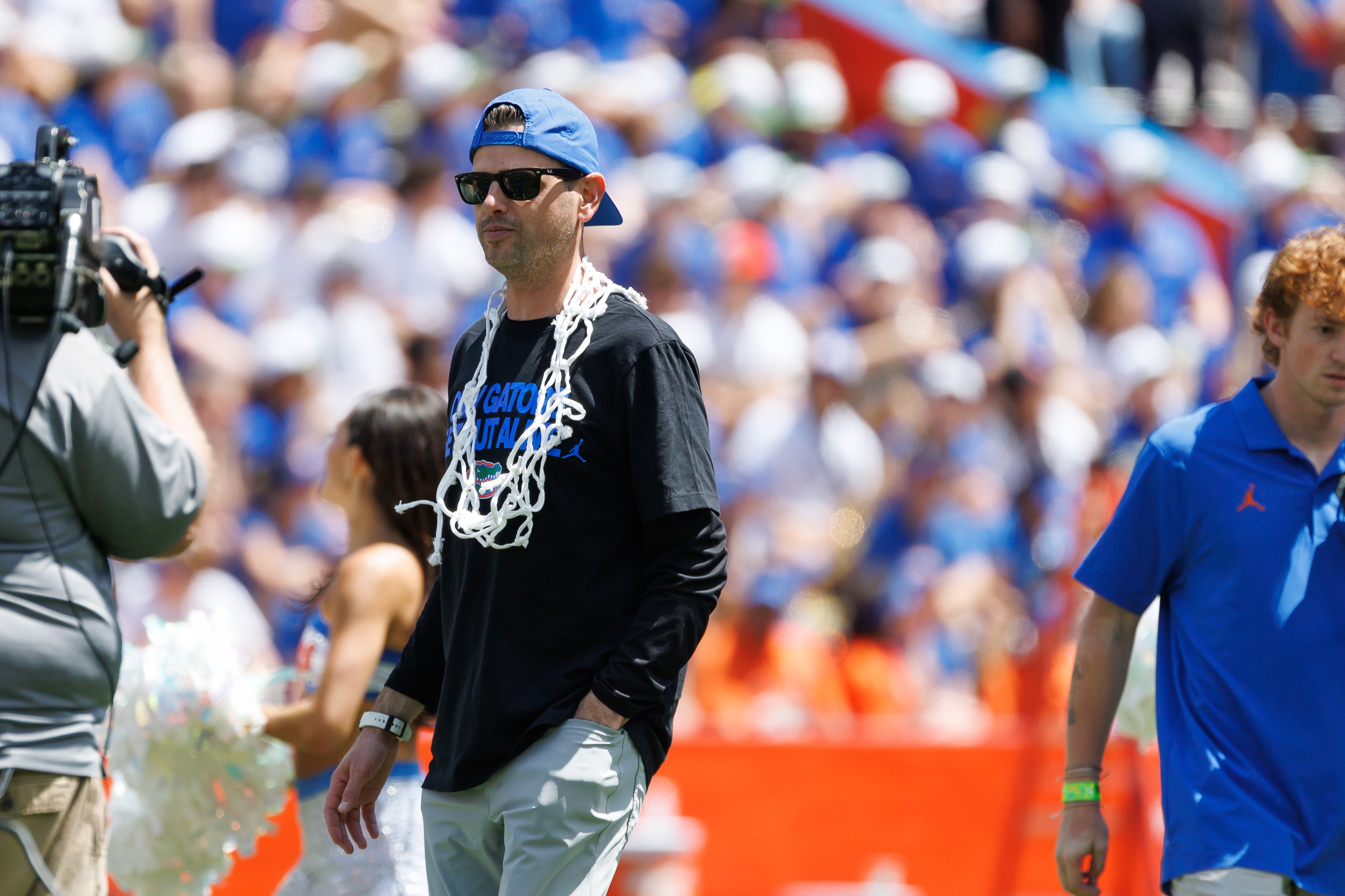 Apr 12, 2025; Gainesville, FL, USA; Florida Gators head coach Todd Golden walks onto the field wearing a net during the National Championship celebration at Ben Hill Griffin Stadium.