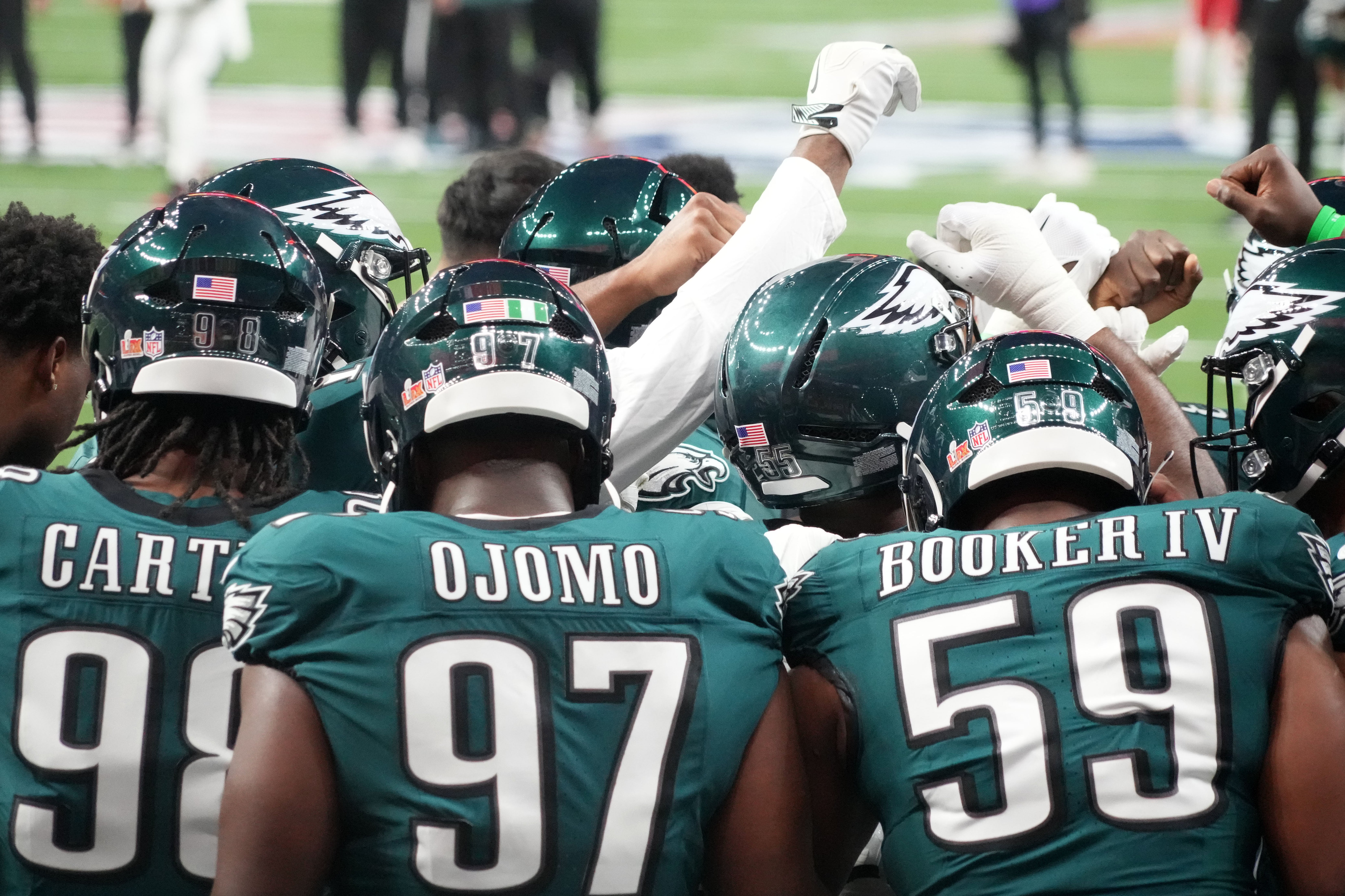 Philadelphia Eagles defensive tackle Moro Ojomo (97), Philadelphia Eagles defensive tackle Jalen Carter (98), and Philadelphia Eagles defensive tackle Thomas Booker IV (59) huddle before Super Bowl LIV.