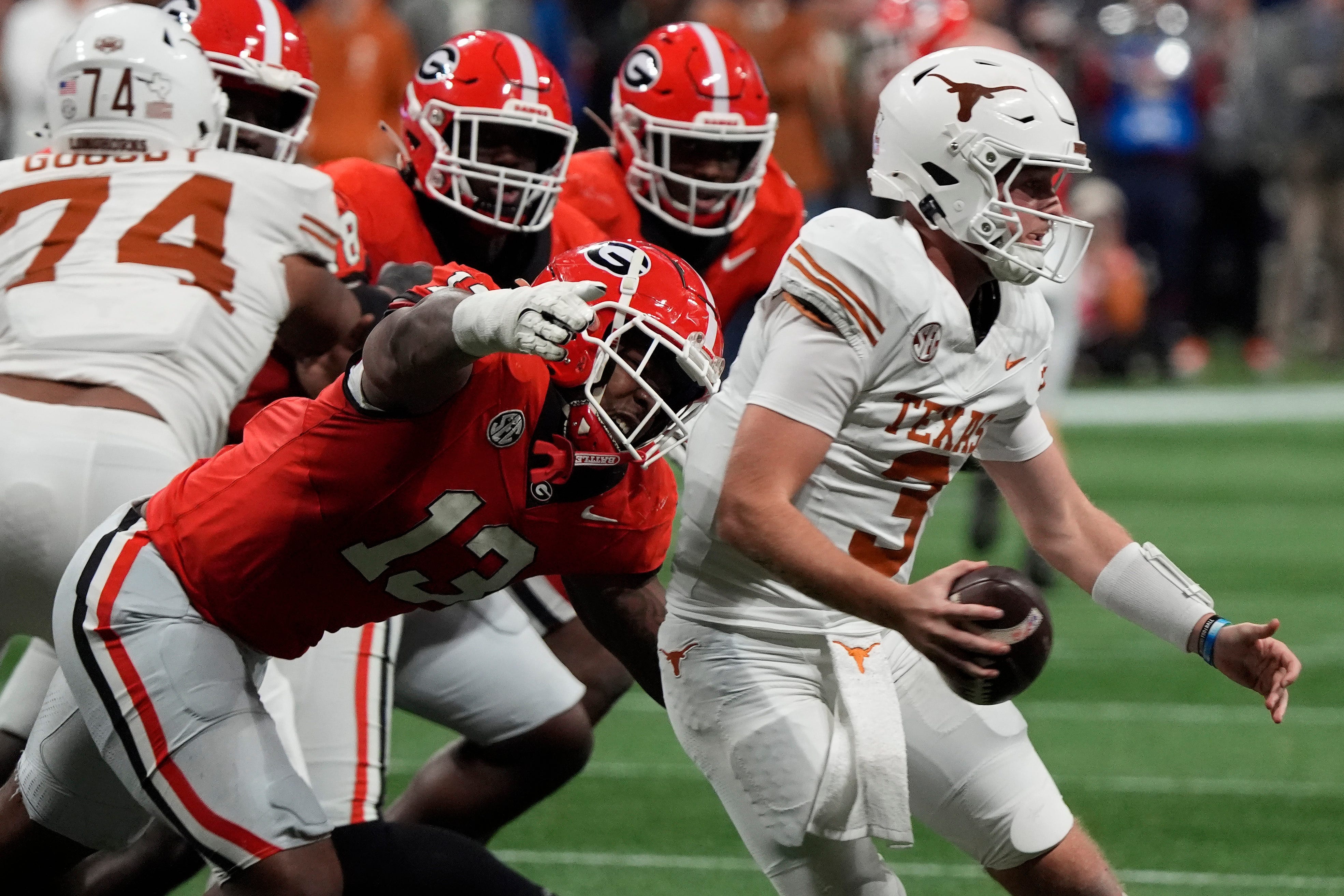 Georgia defensive lineman Mykel Williams (13) goes in for a sack on Texas quarterback Quinn Ewers (3) during the second half of the SEC championship game against Texas in Atlanta, on Saturday, Dec. 7.