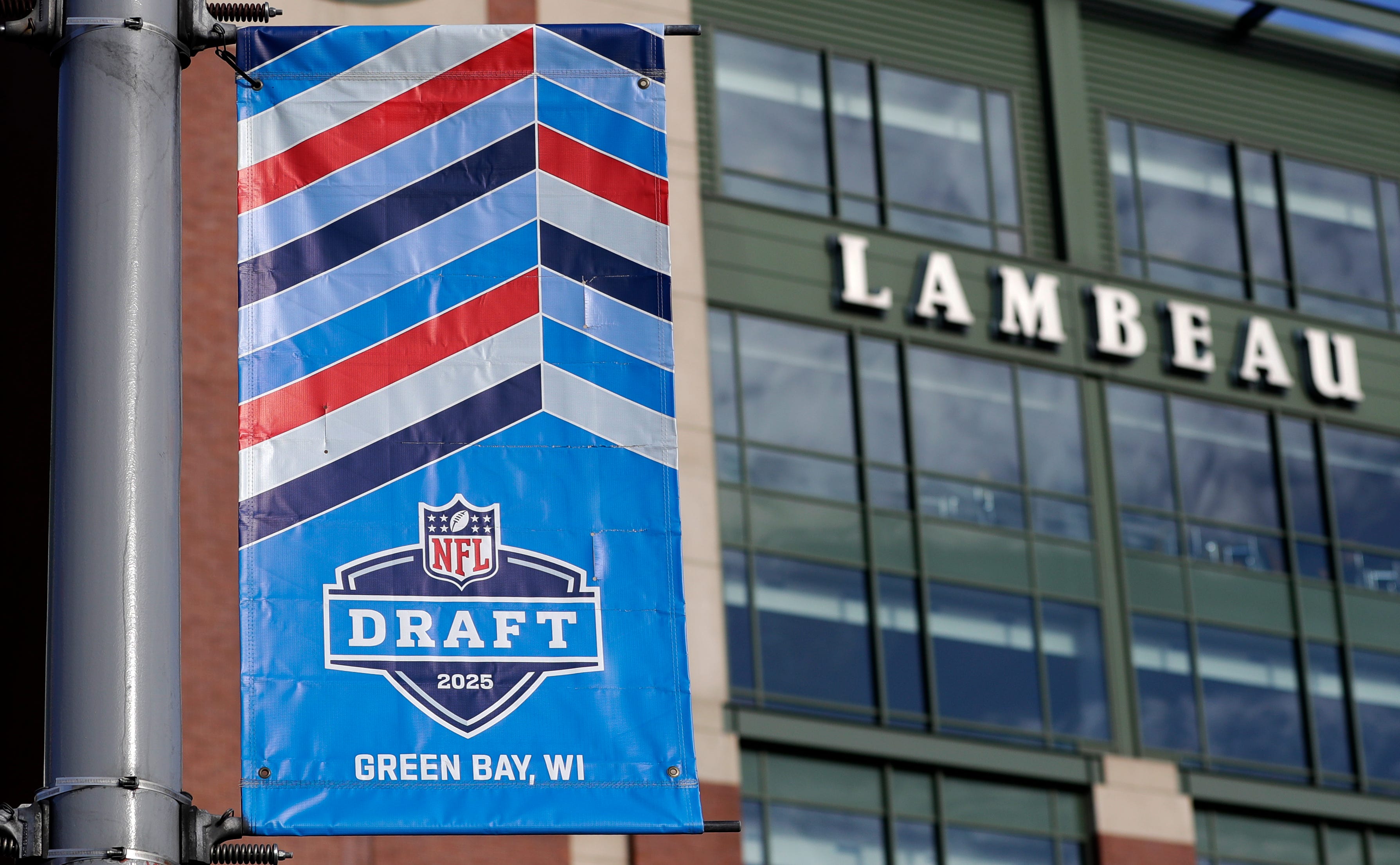 A banner advertising the 2025 NFL Draft on display in the parking lot of Lambeau Field on April 11, 2025, in Green Bay, Wis.