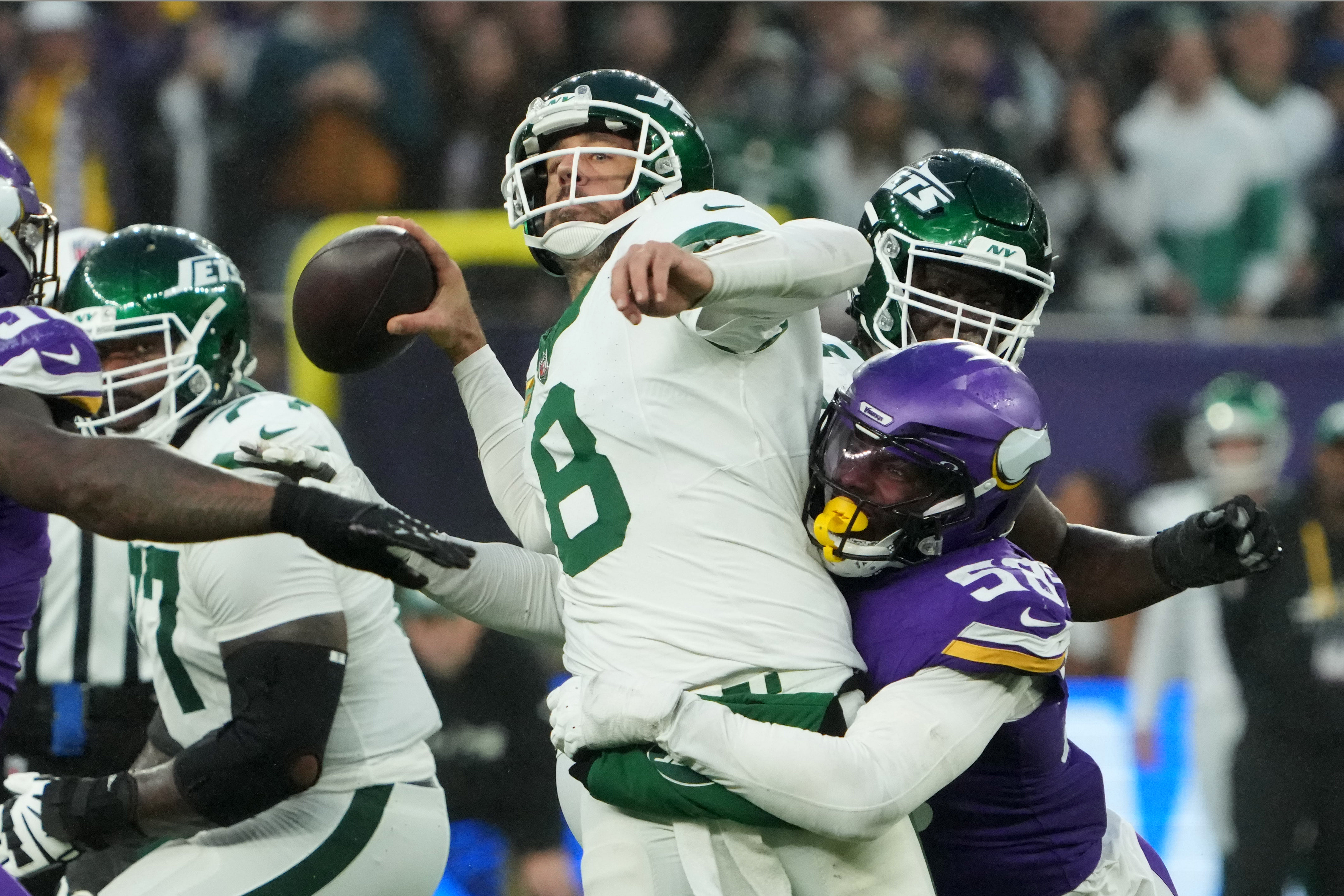 Oct 6, 2024; London, United Kingdom; New York Jets quarterback Aaron Rodgers (8) throws the ball under pressure from Minnesota Vikings linebacker Jonathan Greenard (58) in the fourth quarter at Tottenham Hotspur Stadium.
