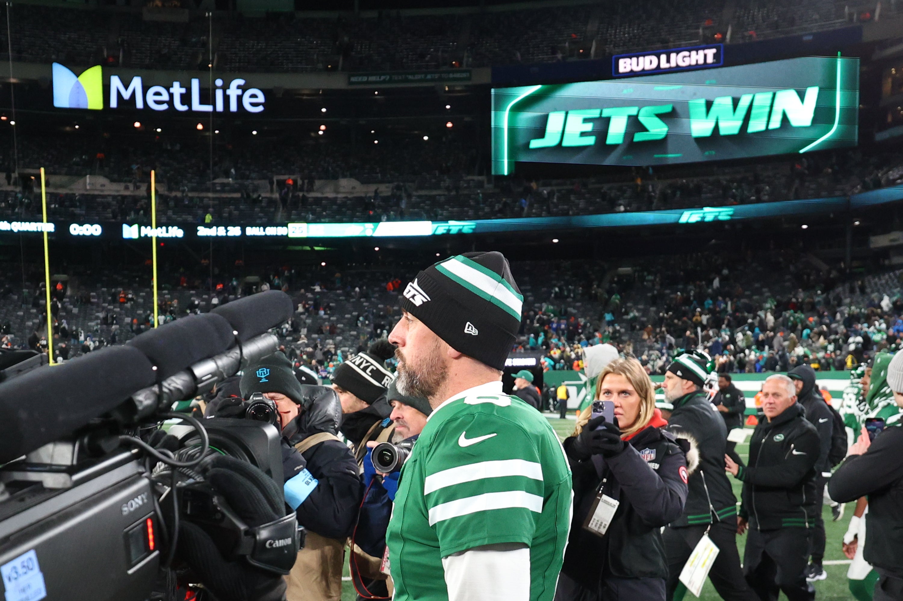 Jan 5, 2025; East Rutherford, New Jersey, USA; New York Jets quarterback Aaron Rodgers (8) walks on the field after the Jets win over the Miami Dolphins at MetLife Stadium.