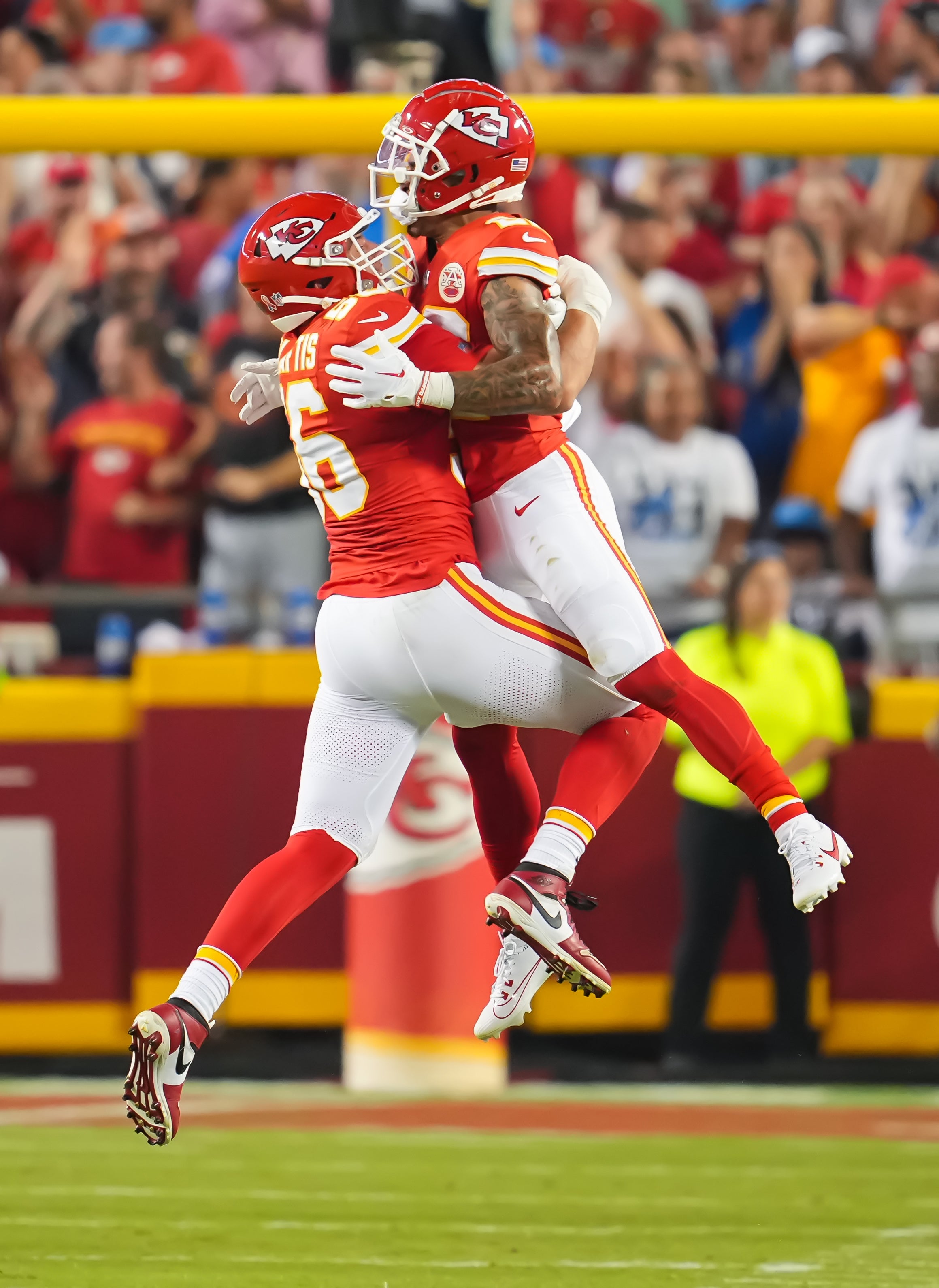 Chiefs cornerback Trent McDuffie (R) celebrates with defensive end George Karlaftis (56) after causing a fumble against the Lions
