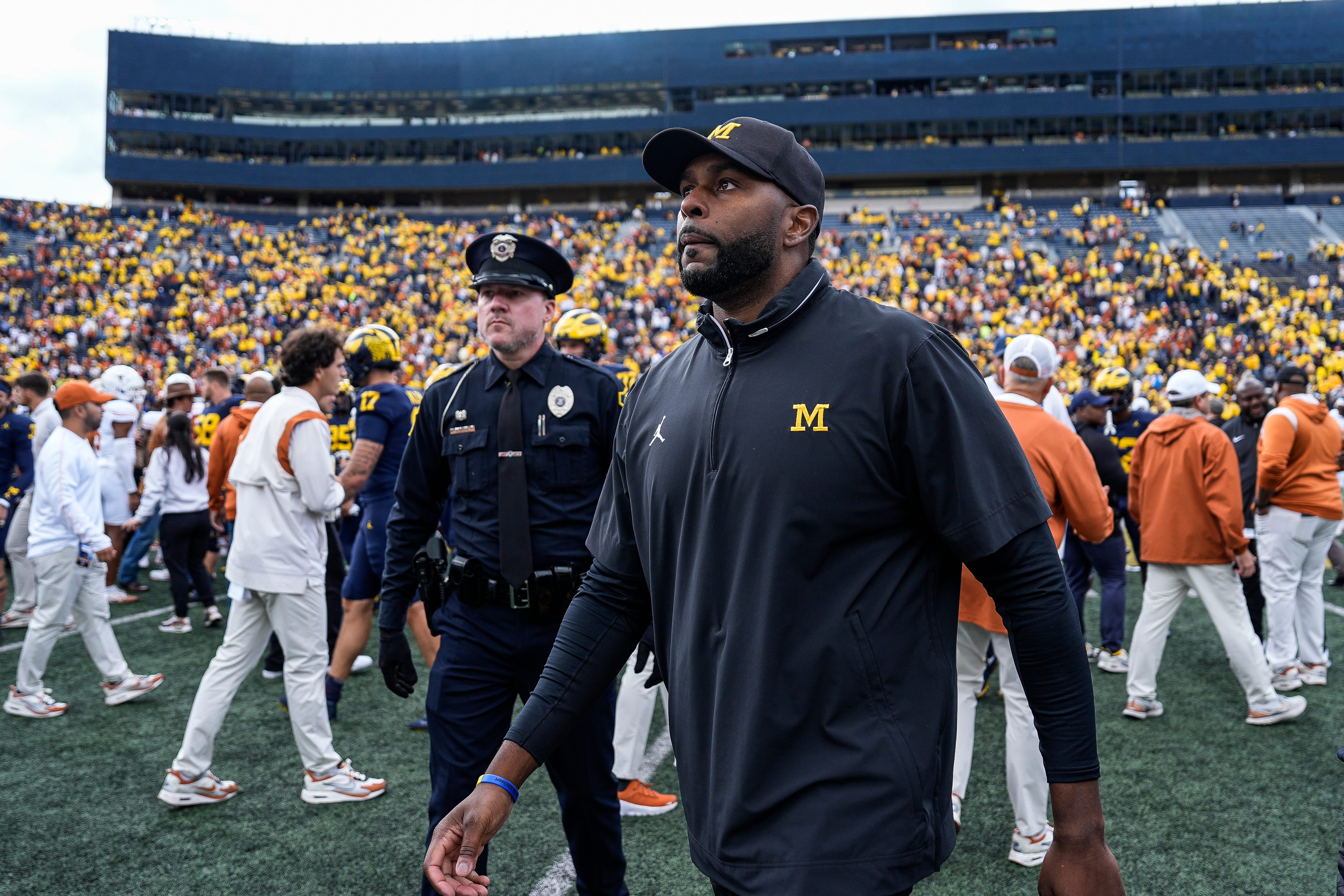 Sherrone Moore, head coach of Michigan Wolverines football, walks off the field after a game
