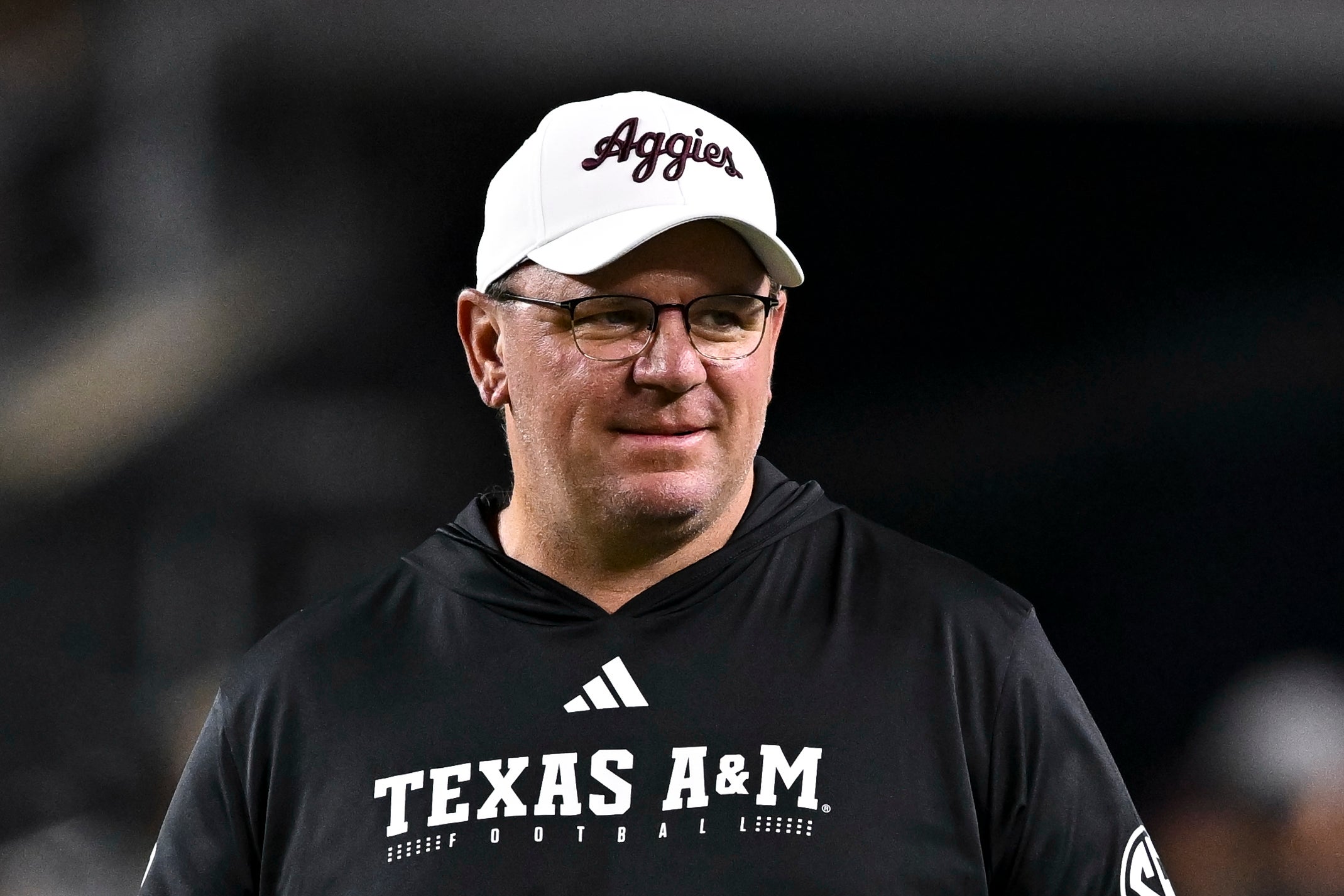Mike Elko, Texas A&M Aggies head coach smiles on the sideline of a game