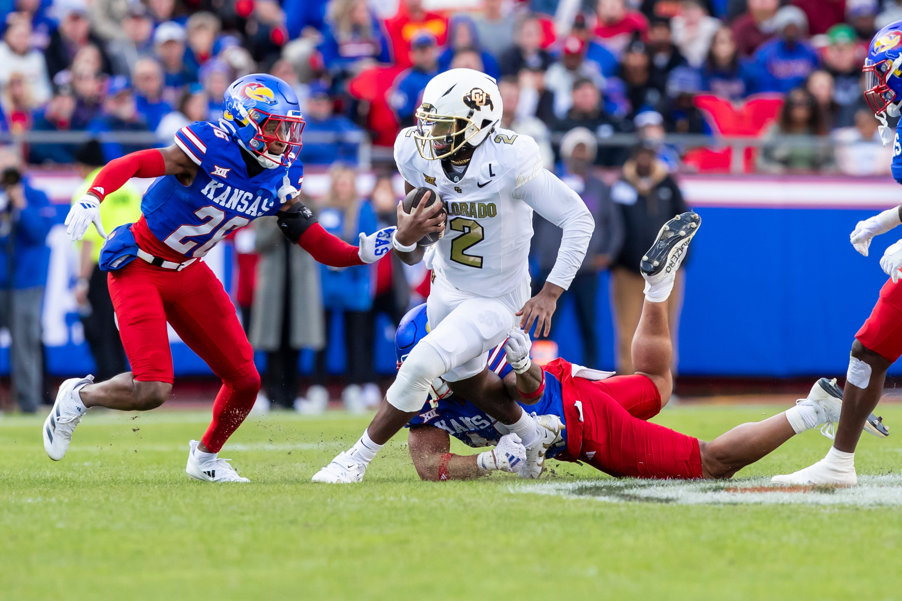 Nov 23, 2024; Kansas City, Missouri, USA; Colorado quarterback Shedeur Sanders (2) scrambles for yardage during the 2nd quarter between the Kansas Jayhawks and the Colorado Buffaloes at GEHA Field at Arrowhead Stadium.