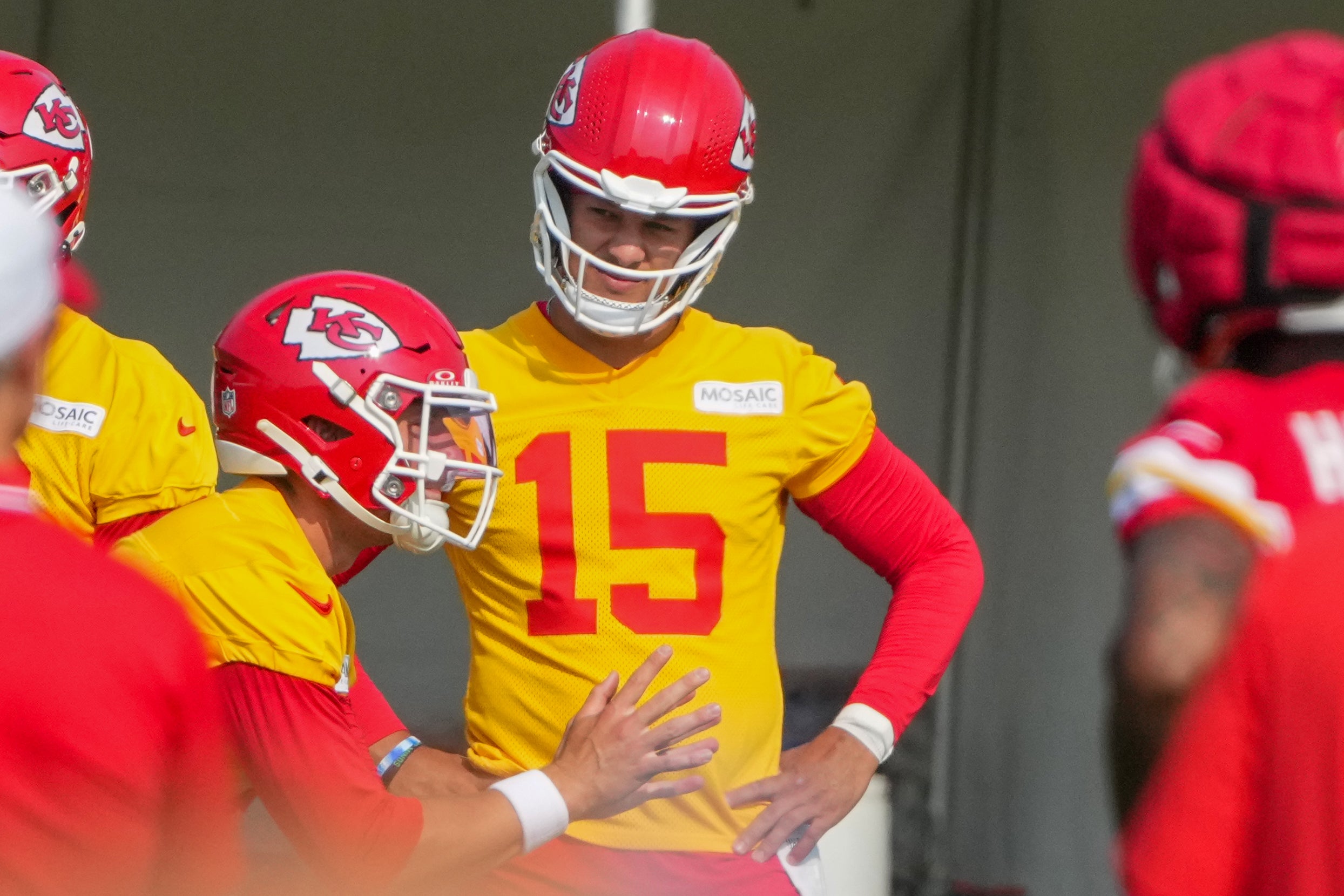 Jul 22, 2024; St. Joseph, MO, USA; Kansas City Chiefs quarterback Patrick Mahomes (15) looks on as quarterback Carson Wentz (11) takes a snap during training camp at Missouri Western State University.