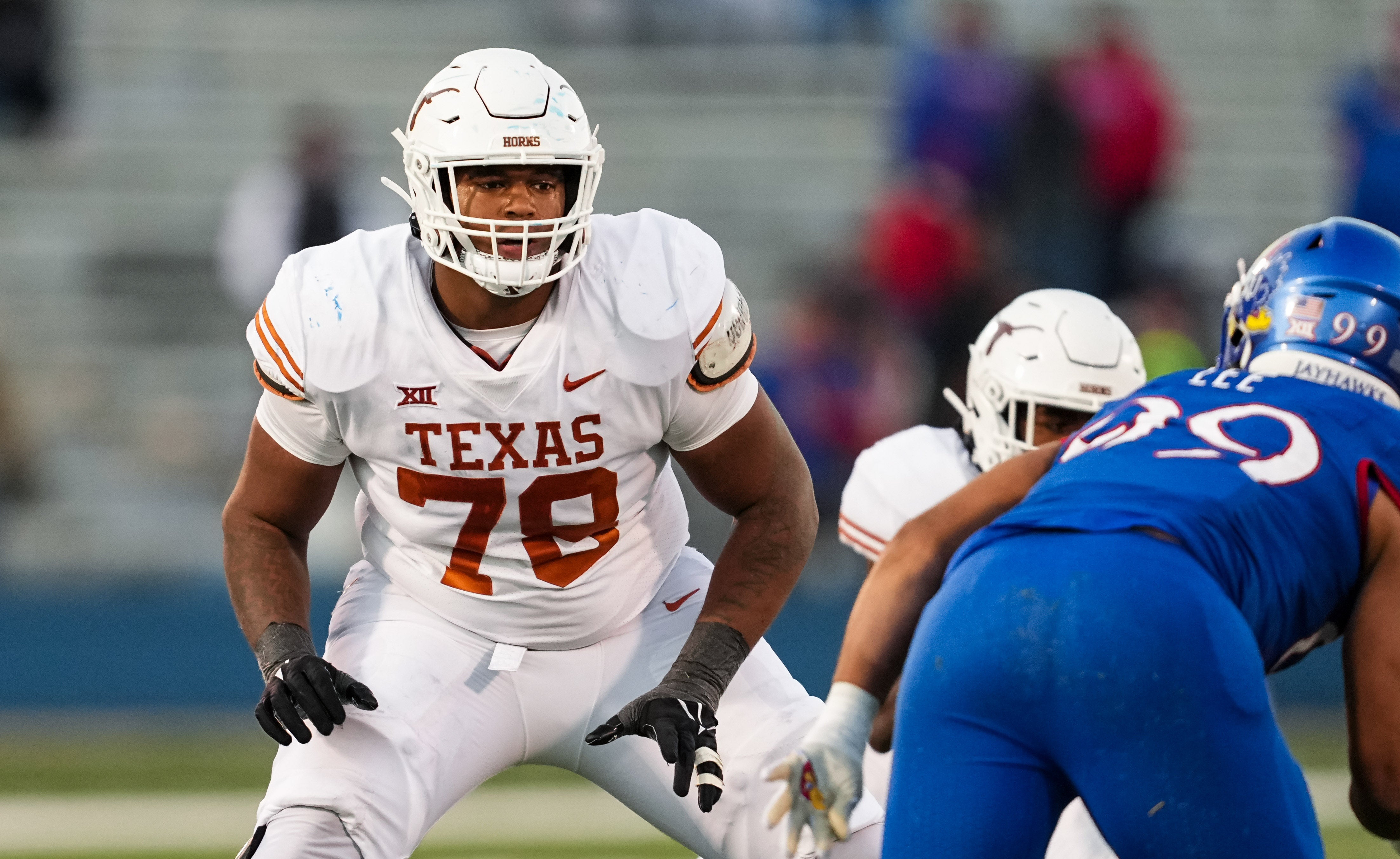 Texas Longhorns offensive lineman Kelvin Banks Jr. (78) looks to block Kansas Jayhawks defensive lineman Malcolm Lee (99) during the second half at David Booth Kansas Memorial Stadium.