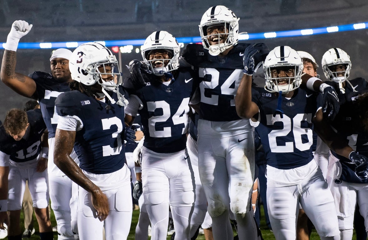 Penn State football players, including Cam Wallace (26), Ta'Mere Robinson (24), London Montgomery (24) and Dante Cephas (3), celebrate following a 63-0 win against Massachusetts on homecoming weekend Saturday, Oct.14, 2023, in State College, Pa.