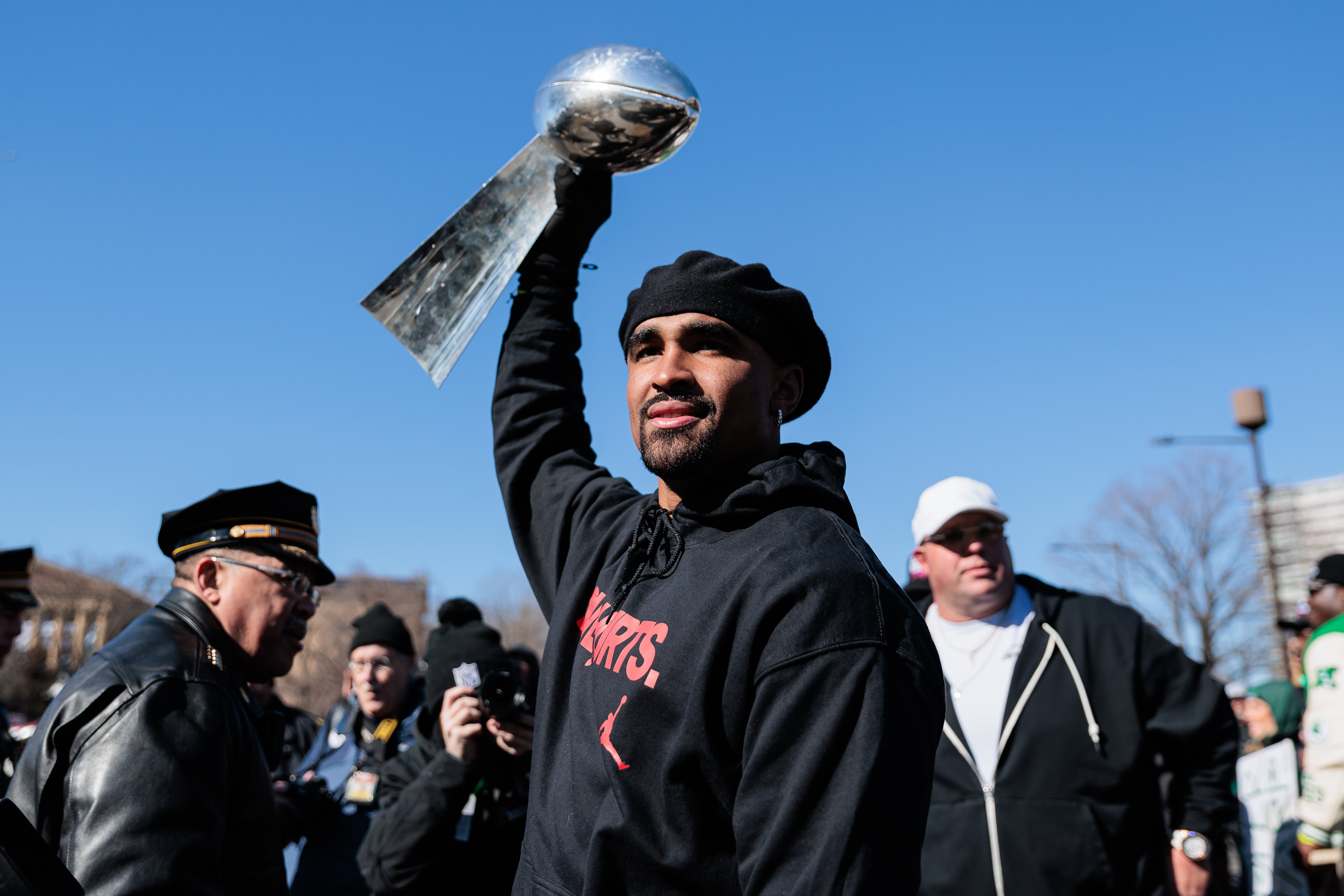 Philadelphia Eagles quarterback Jalen Hurts (1) raises the Lombardi Trophy during the Super Bowl LIX championship parade and rally.