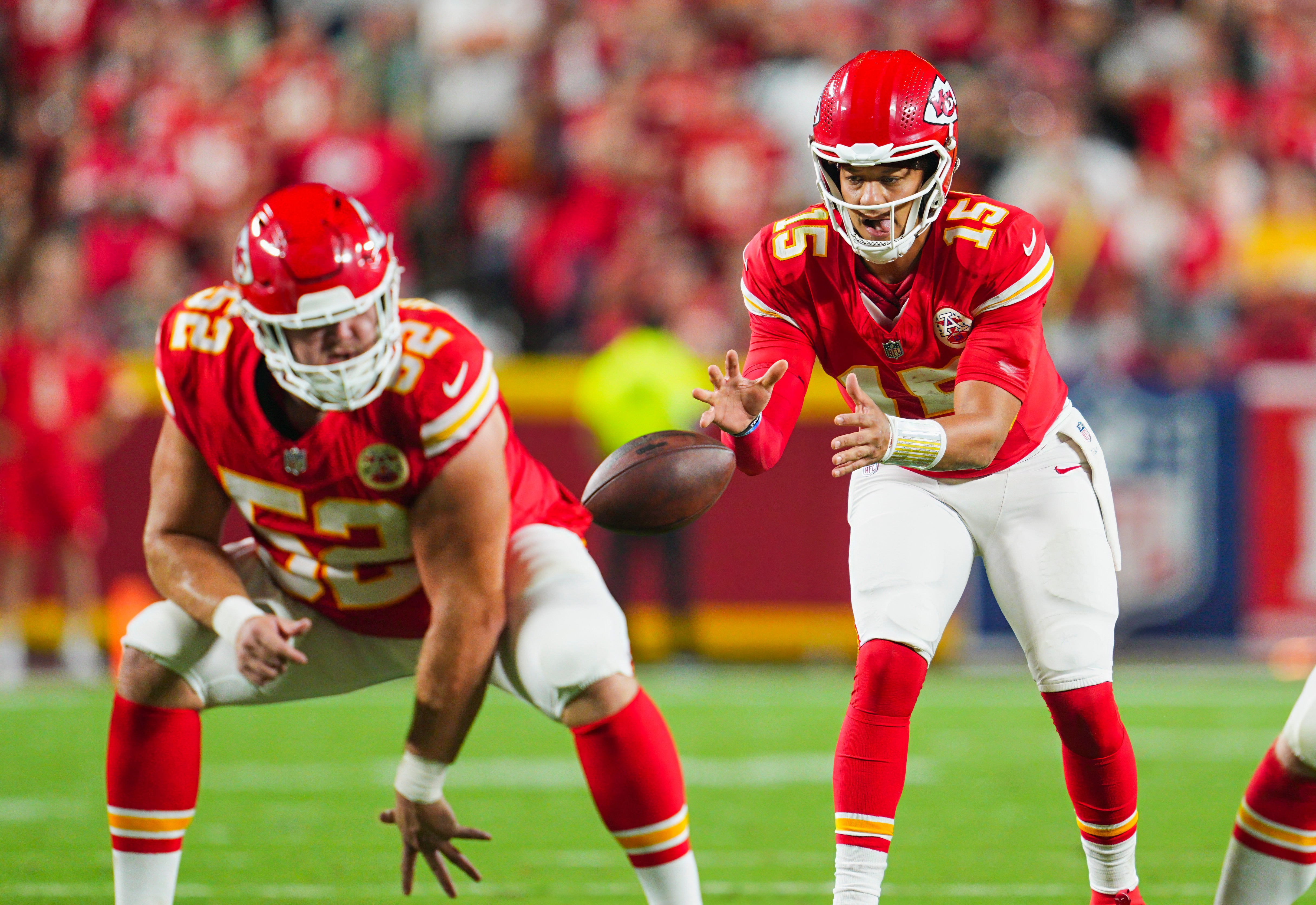 Chiefs quarterback Patrick Mahomes (15) takes the snap from center Creed Humphrey (52) during the second half against the Ravens