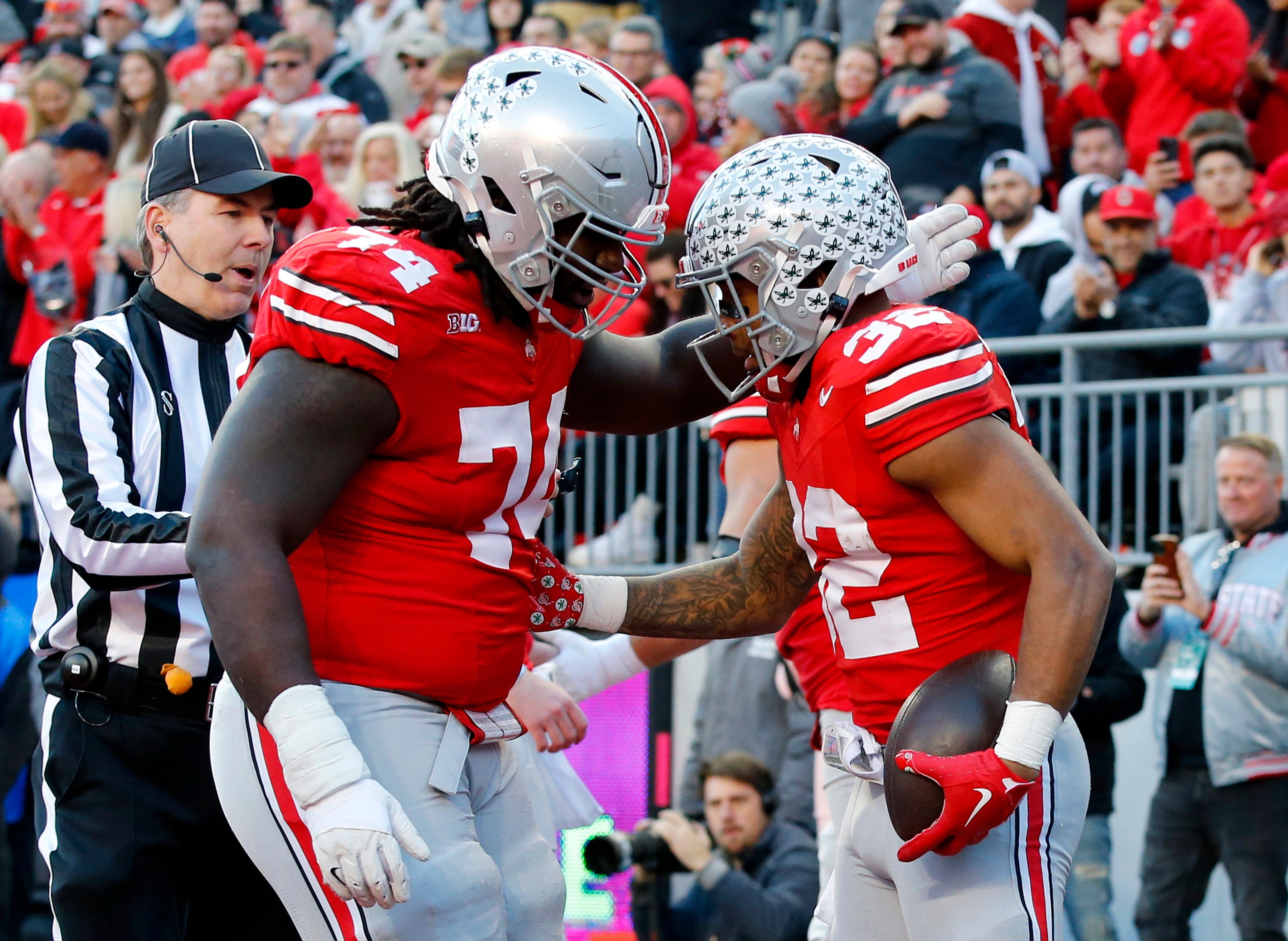Nov 18, 2023; Columbus, Ohio, USA; Ohio State Buckeyes running back TreVeyon Henderson (32) celebrates his touchdown run with offensive lineman Donovan Jackson (74) during the first quarter against the Minnesota Golden Gophers at Ohio Stadium.