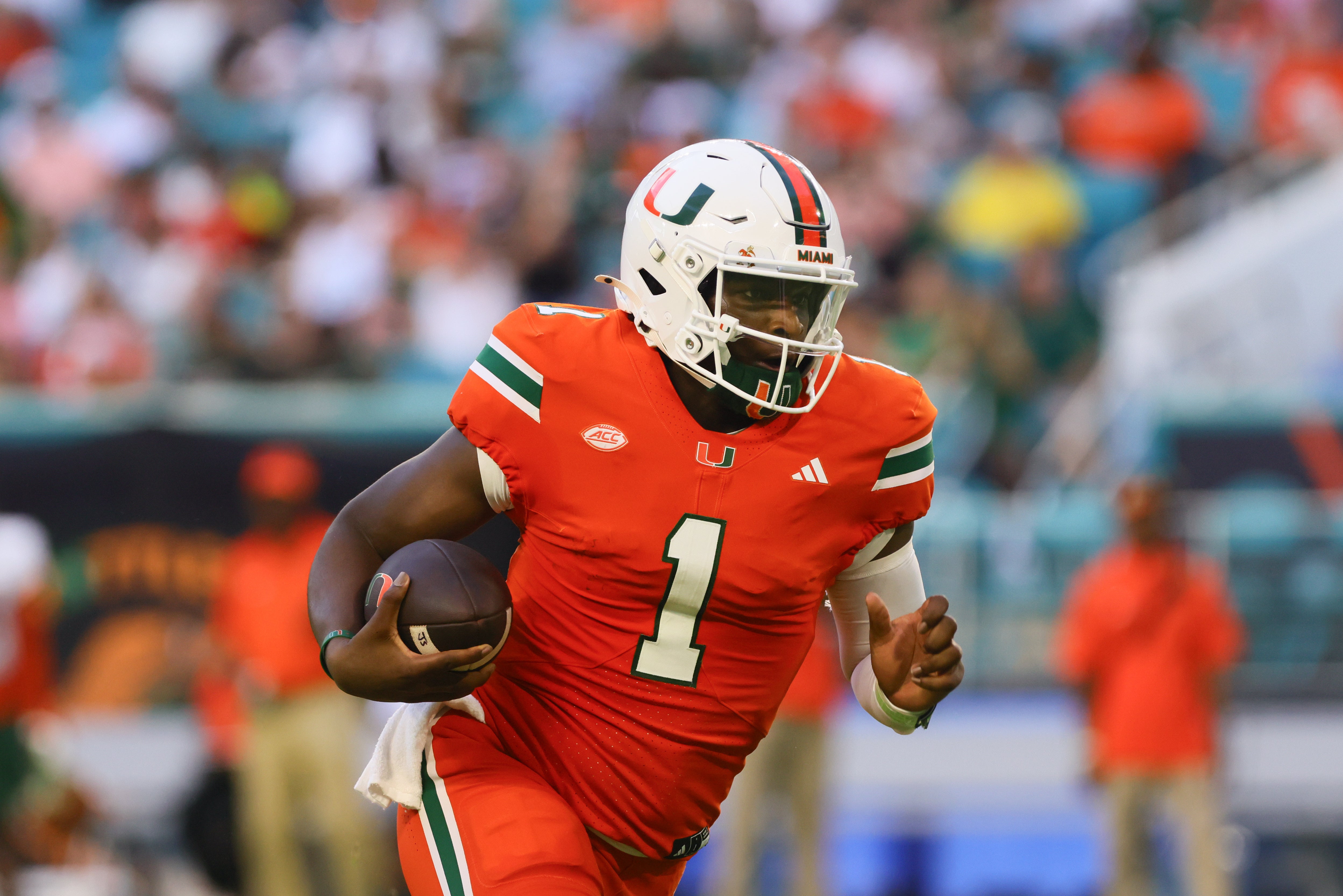 Miami Hurricanes quarterback Cam Ward (1) runs with the football against the Florida A&M Rattlers during the second quarter at Hard Rock Stadium. Sam Navarro-Imagn Images