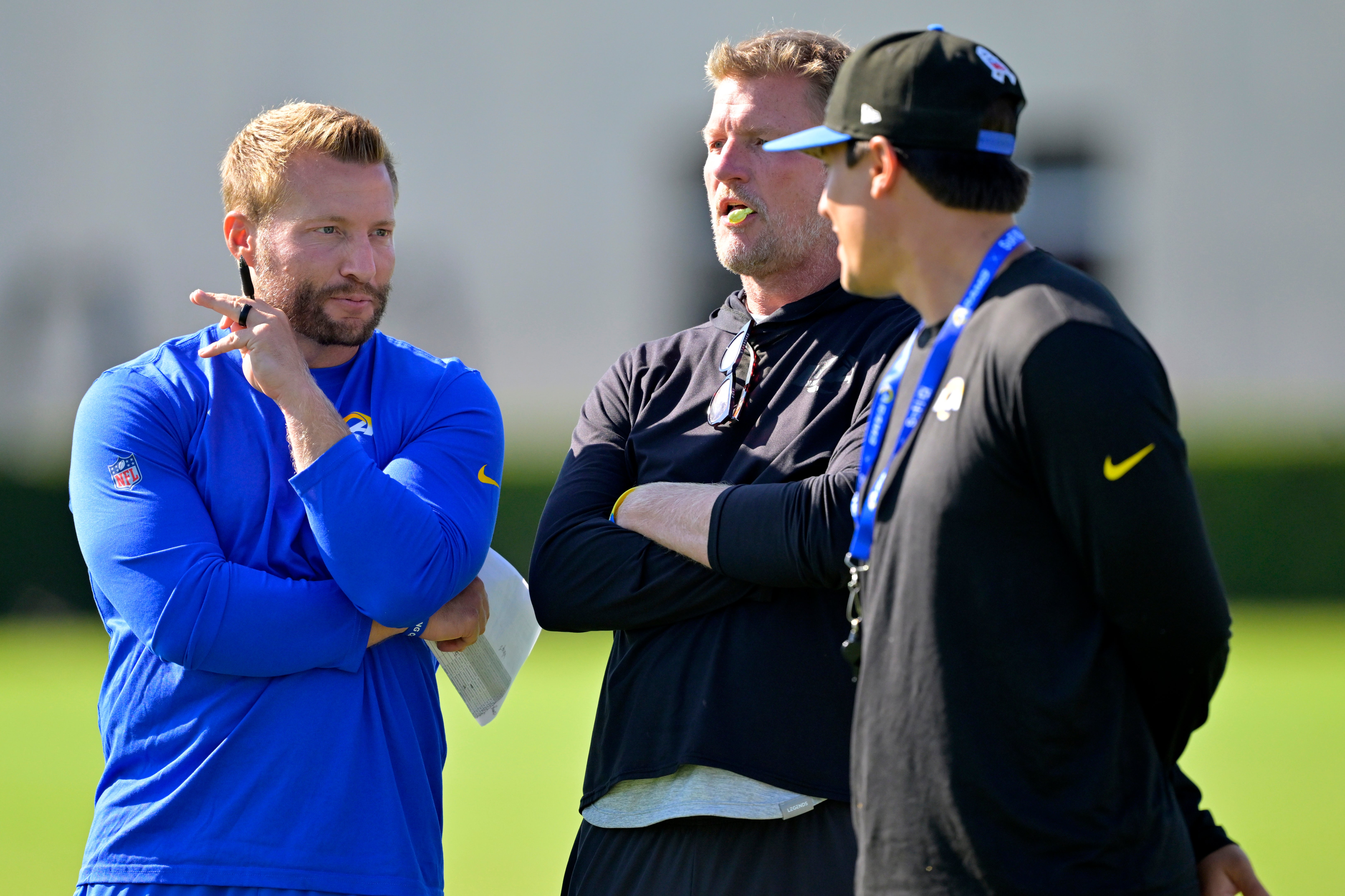 Jul 29, 2024; Los Angeles, CA, USA; Los Angeles Rams head coach Sean McVay, general manager Les Snead and chief of staff Carter Crutchfield talk on the field during training camp at Loyola Marymount University.