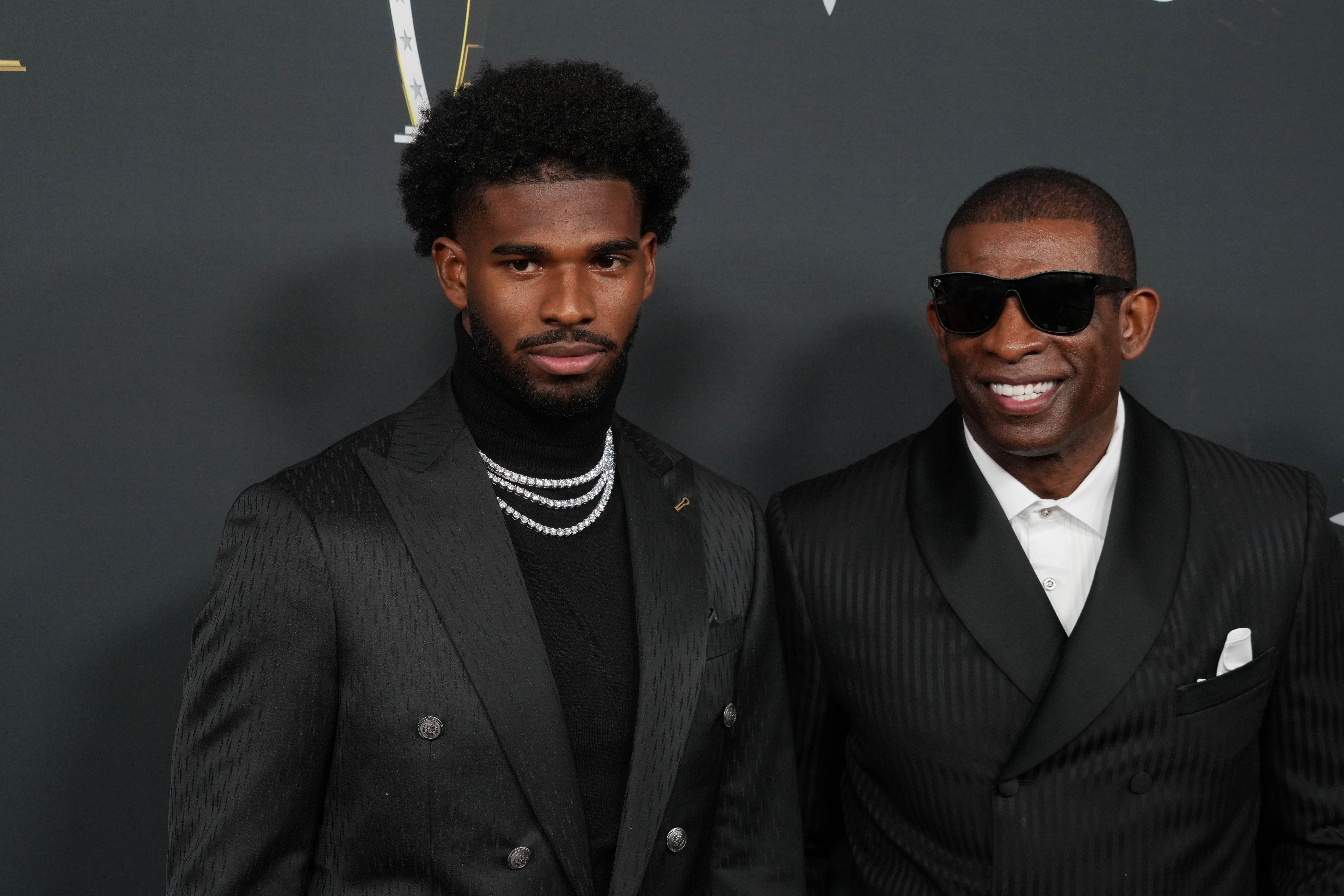 Deion Sanders (right) with his son Shedeur Sanders on the red carpet before Super Bowl LIX NFL Honors at Saenger Theatre. Kirby Lee-Imagn Images