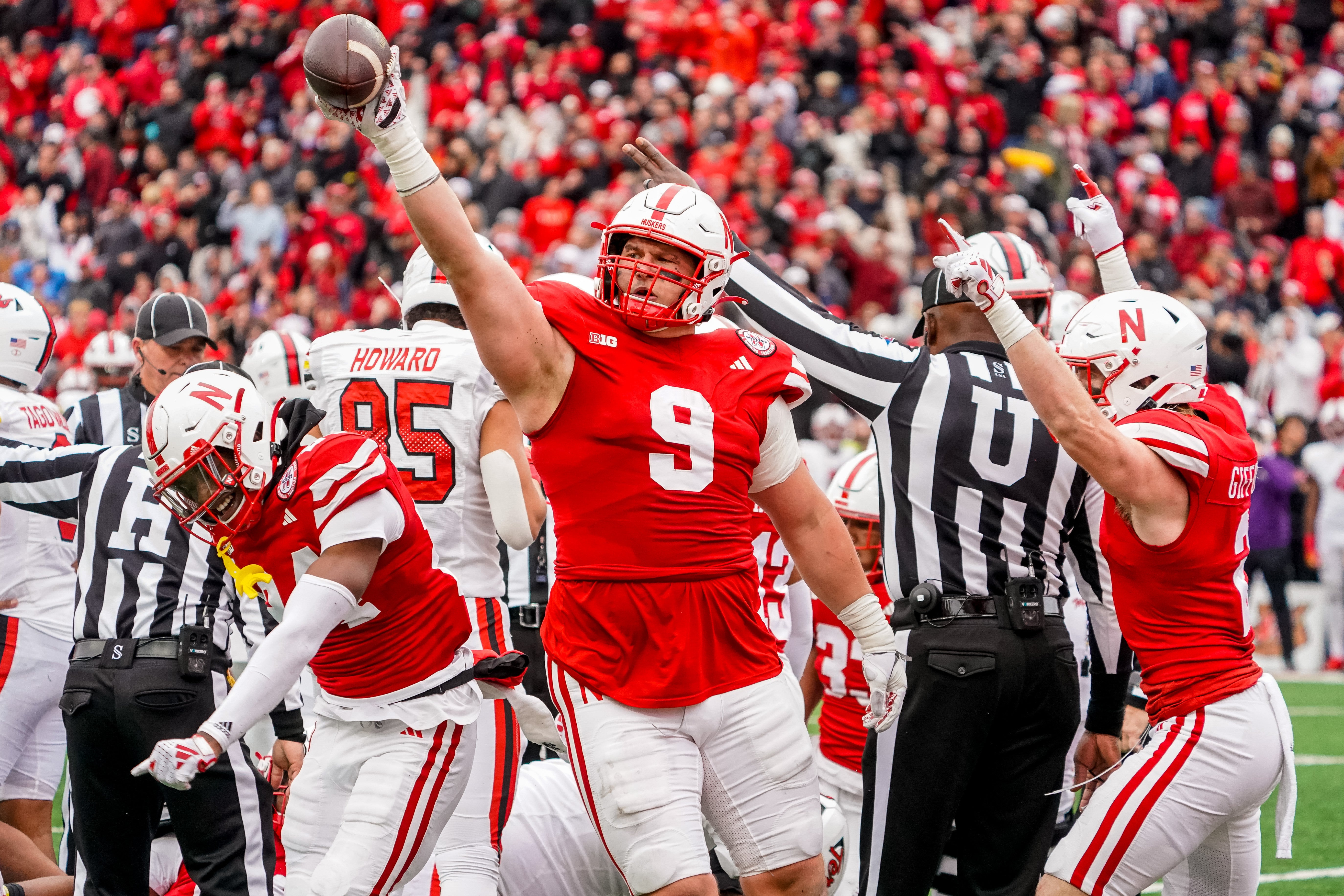 Nov 11, 2023; Lincoln, Nebraska, USA; Nebraska Cornhuskers defensive lineman Ty Robinson (9), linebacker Luke Reimer (4), and defensive back Isaac Gifford (2) celebrate after recovering a fumble against the Maryland Terrapins during the fourth quarter at Memorial Stadium.