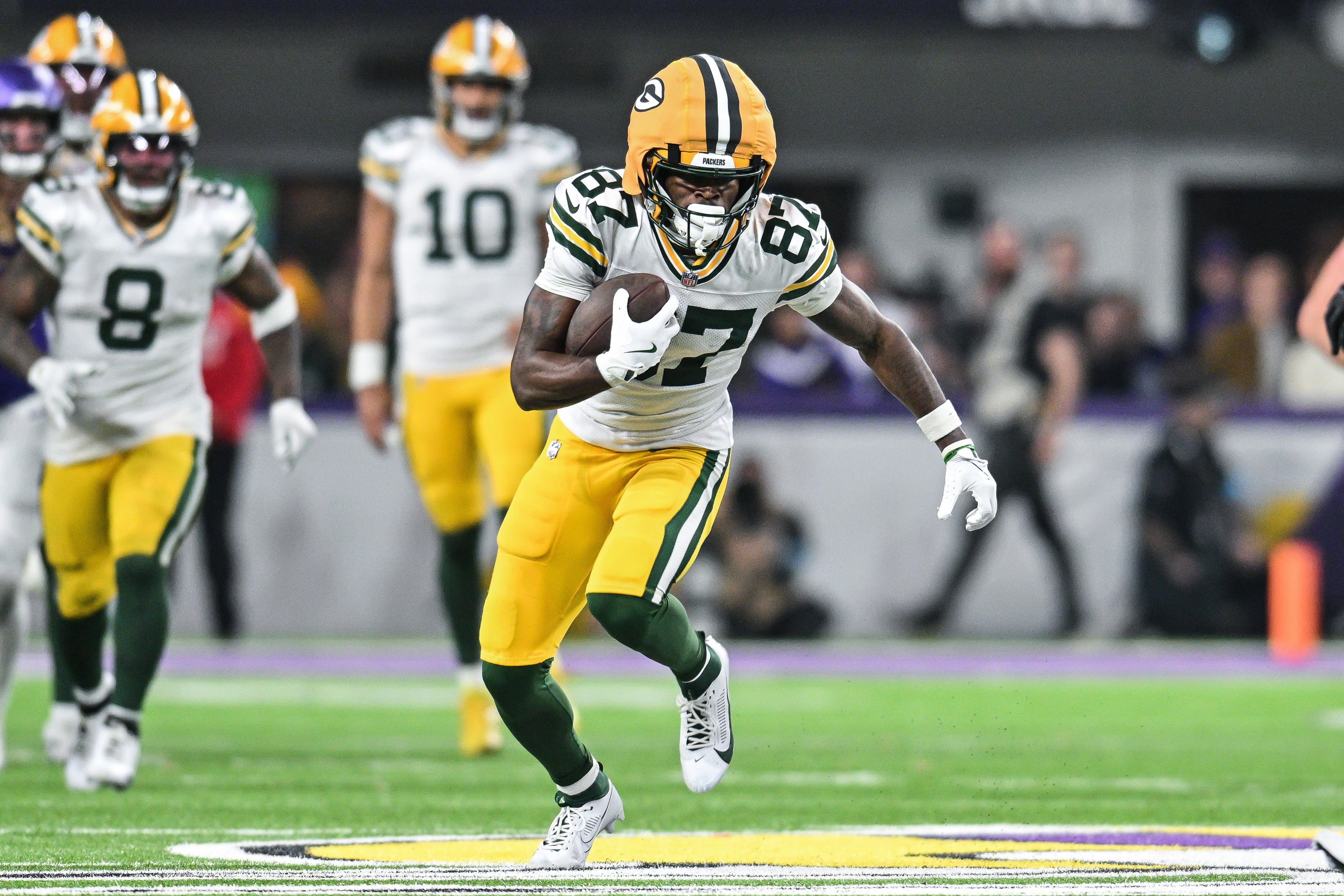 Green Bay Packers wide receiver Romeo Doubs (87) gets yards after the catch against the Minnesota Vikings during the fourth quarter at U.S. Bank Stadium.