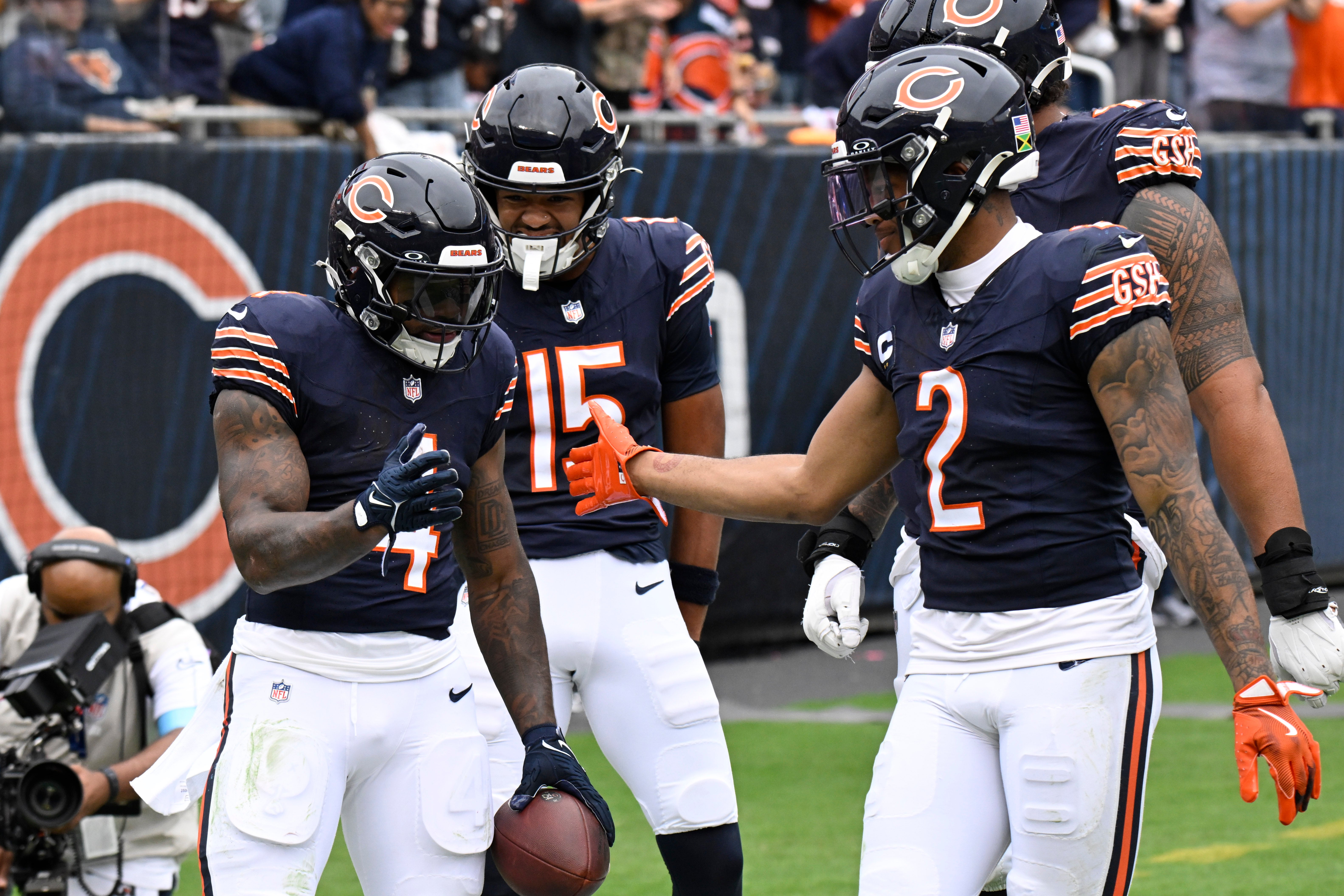 Sep 29, 2024; Chicago, Illinois, USA; Chicago Bears running back D'Andre Swift (4) celebrates with wide receiver DJ Moore (2) after he runs for a touchdown against the Los Angeles Rams during the second half at Soldier Field.