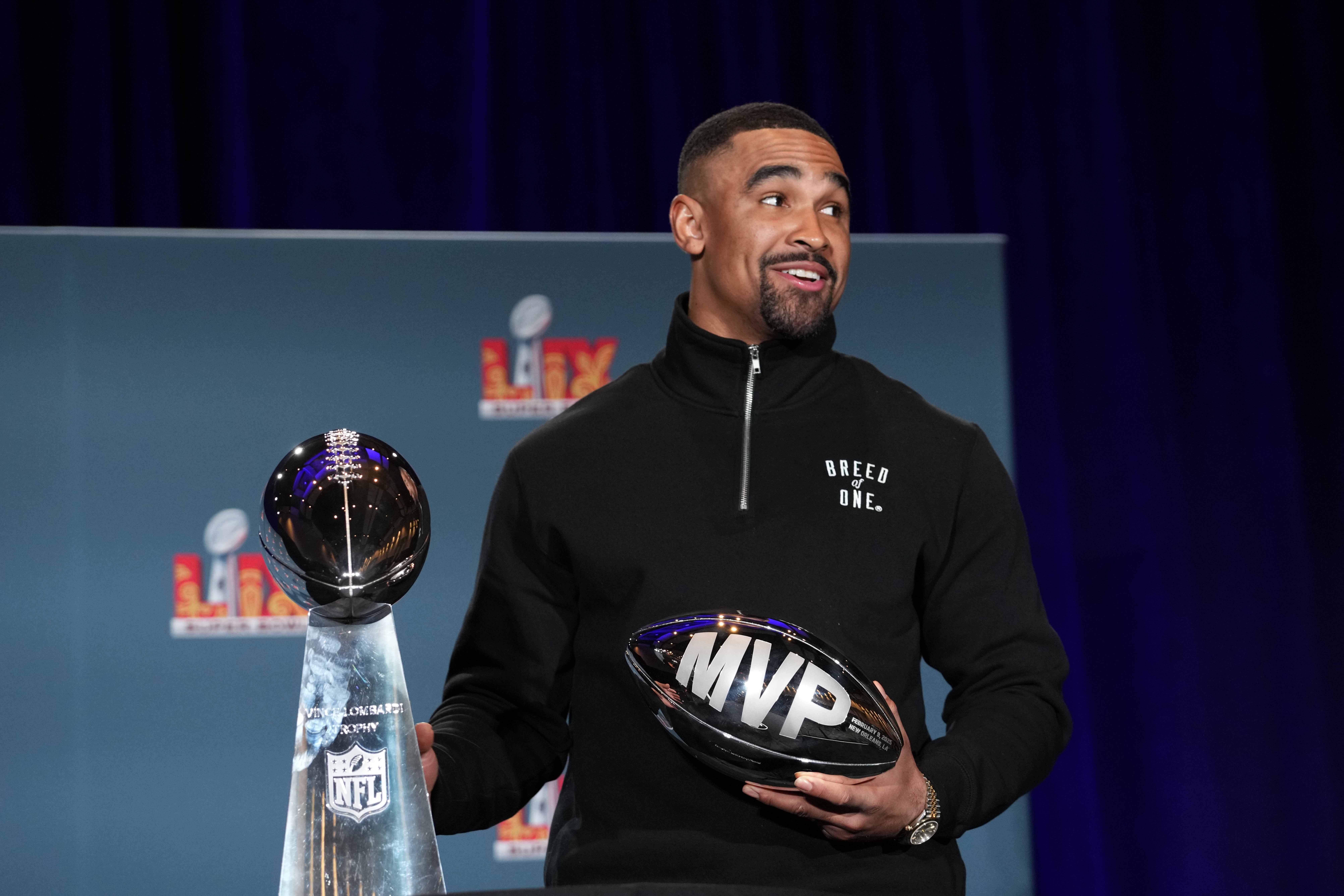 Philadelphia Eagles quarterback Jalen Hurts (1) poses with the Vince Lombardi trophy at the Super Bowl LIX Winning Head Coach and Most Valuable Player press conference.