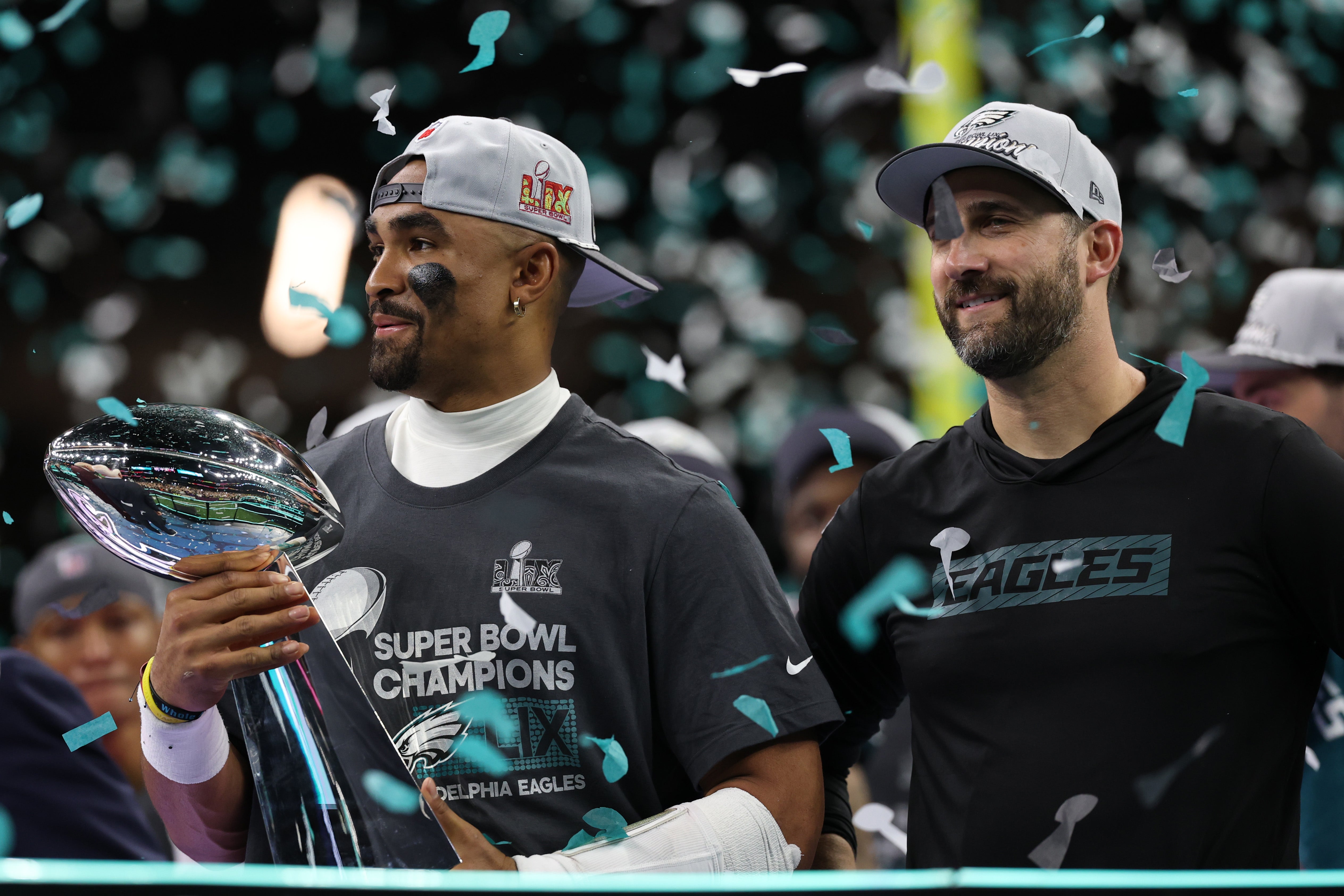 Philadelphia Eagles quarterback Jalen Hurts holds the Lombardi Trophy while standing next to Eagles head coach Nick Sirianni (R) during the championship trophy presentation after the Eagles' game again.