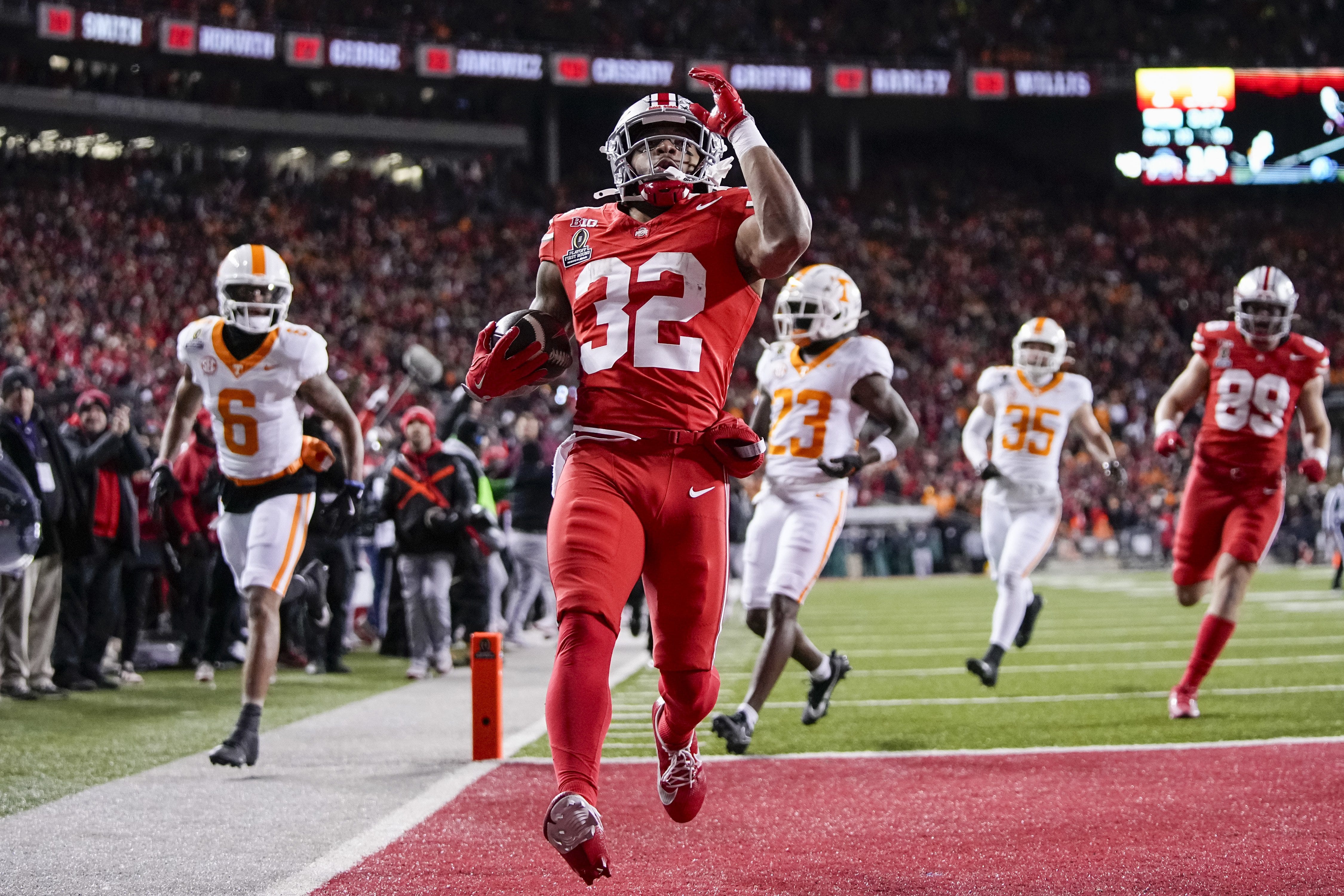 Ohio State Buckeyes running back TreVeyon Henderson (32) runs for a touchdown during the first half of the College Football Playoff first round game against the Tennessee Volunteers at Ohio Stadium in Columbus on Dec. 21, 2024.