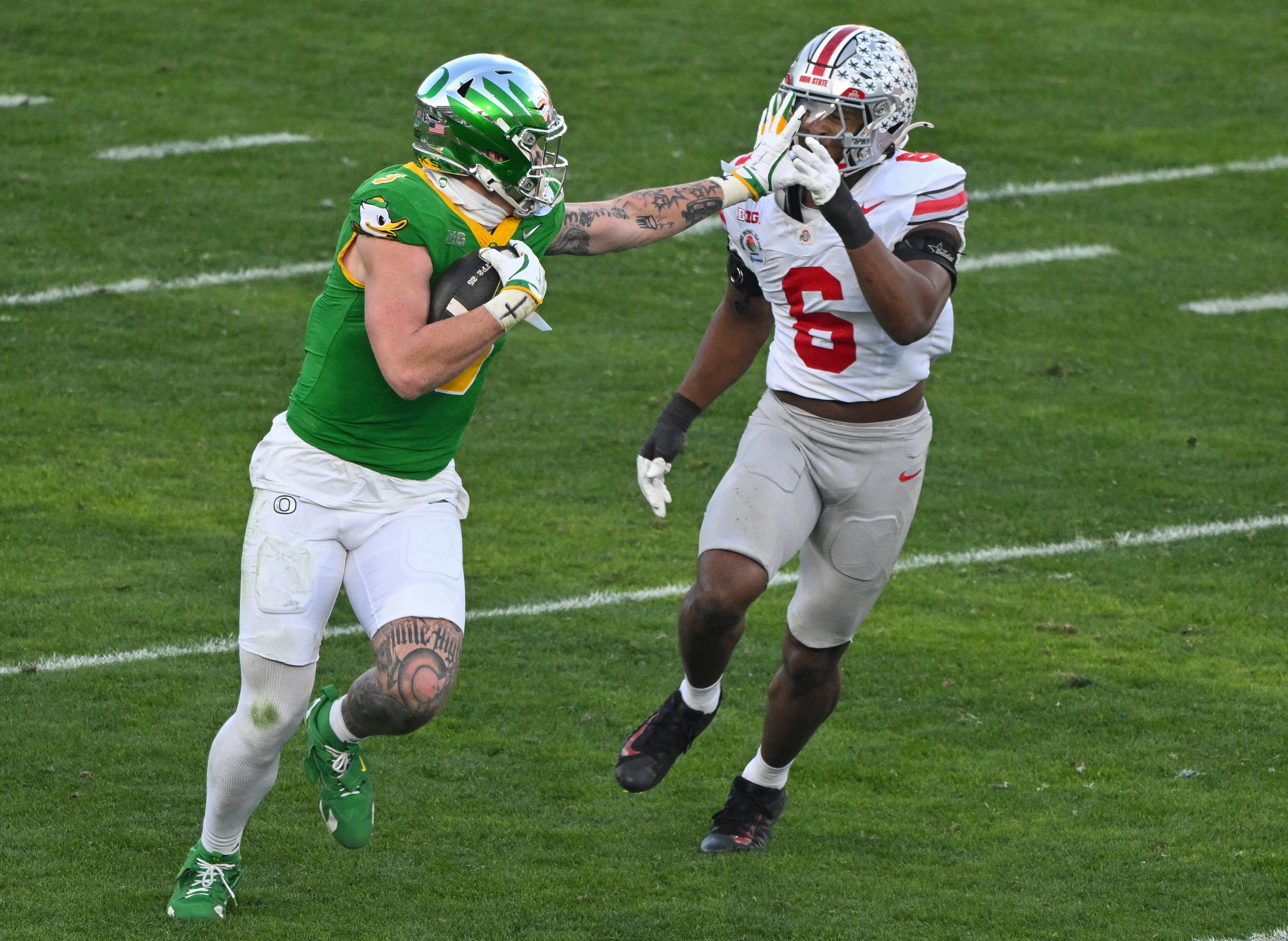 Jan 1, 2025; Pasadena, CA, USA; Oregon Ducks tight end Terrance Ferguson (3) stiff arms Ohio State Buckeyes safety Lathan Ransom (8) during a third quarter pass play at Rose Bowl Stadium.