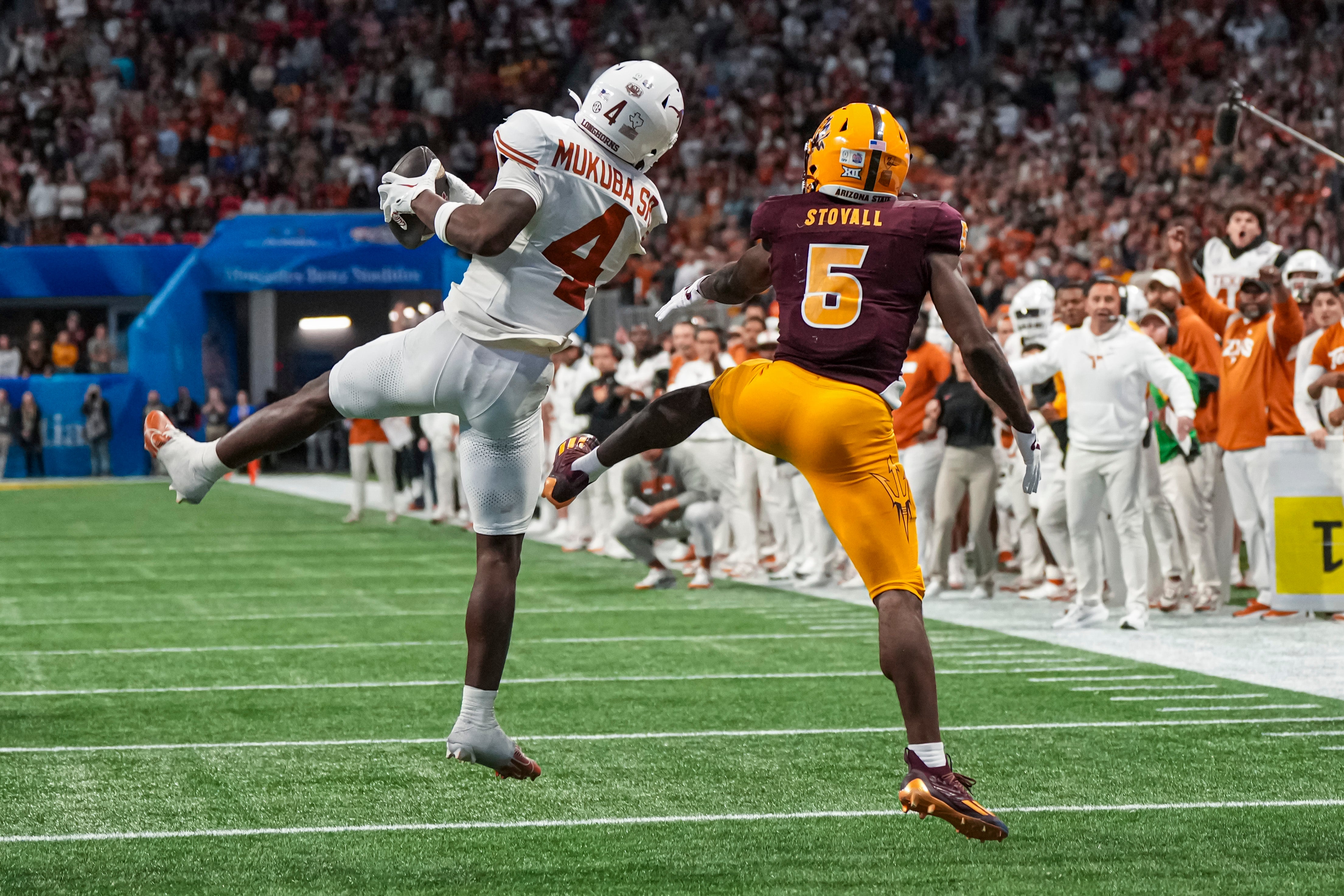 Texas Longhorns defensive back Andrew Mukuba (4) intercepts a pass in front of Arizona State Sun Devils wide receiver Melquan Stovall (5) to end the game in the second overtime at Mercedes-Benz Stadium.
