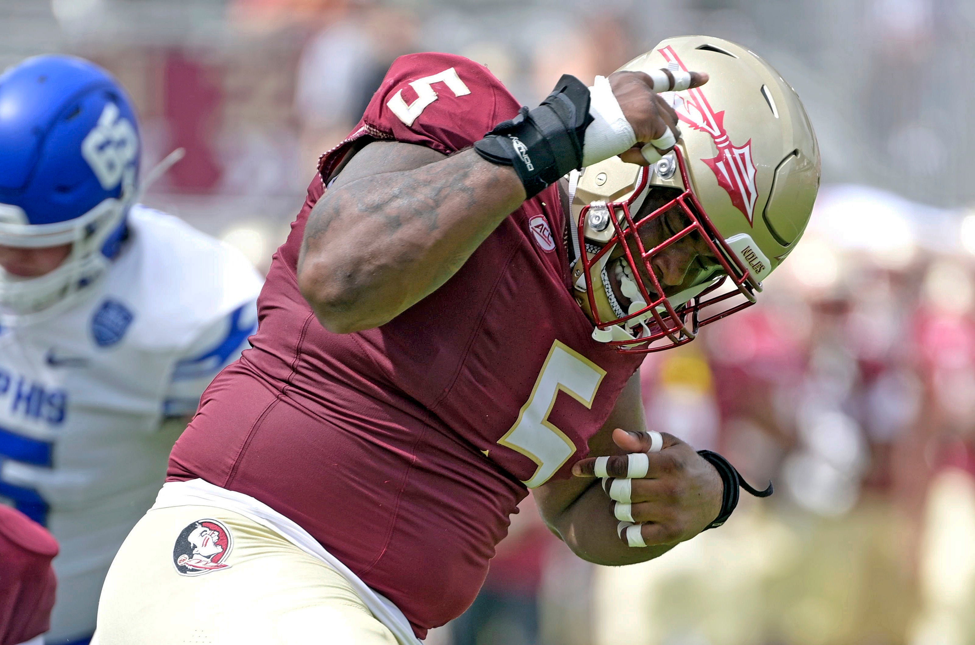 Sep 14, 2024; Tallahassee, Florida, USA; Florida State Seminoles defensive lineman Joshua Farmer (5) celebrates after a defensive stop against the Memphis Tigers during the first half at Doak S. Campbell Stadium.