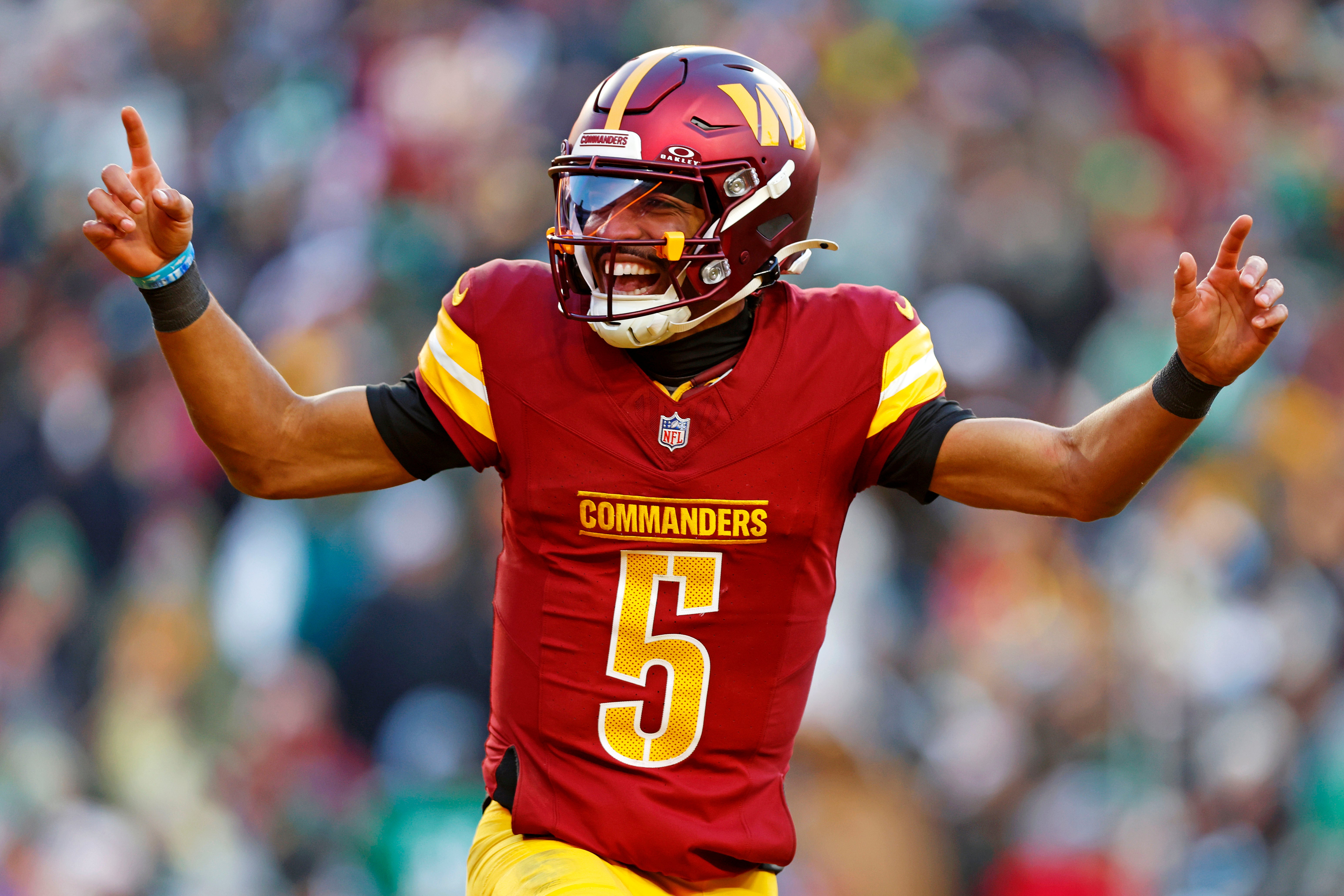 Dec 22, 2024; Landover, Maryland, USA; Washington Commanders quarterback Jayden Daniels (5) celebrates after throwing a touchdown during the fourth quarter against the Philadelphia Eagles at Northwest Stadium.