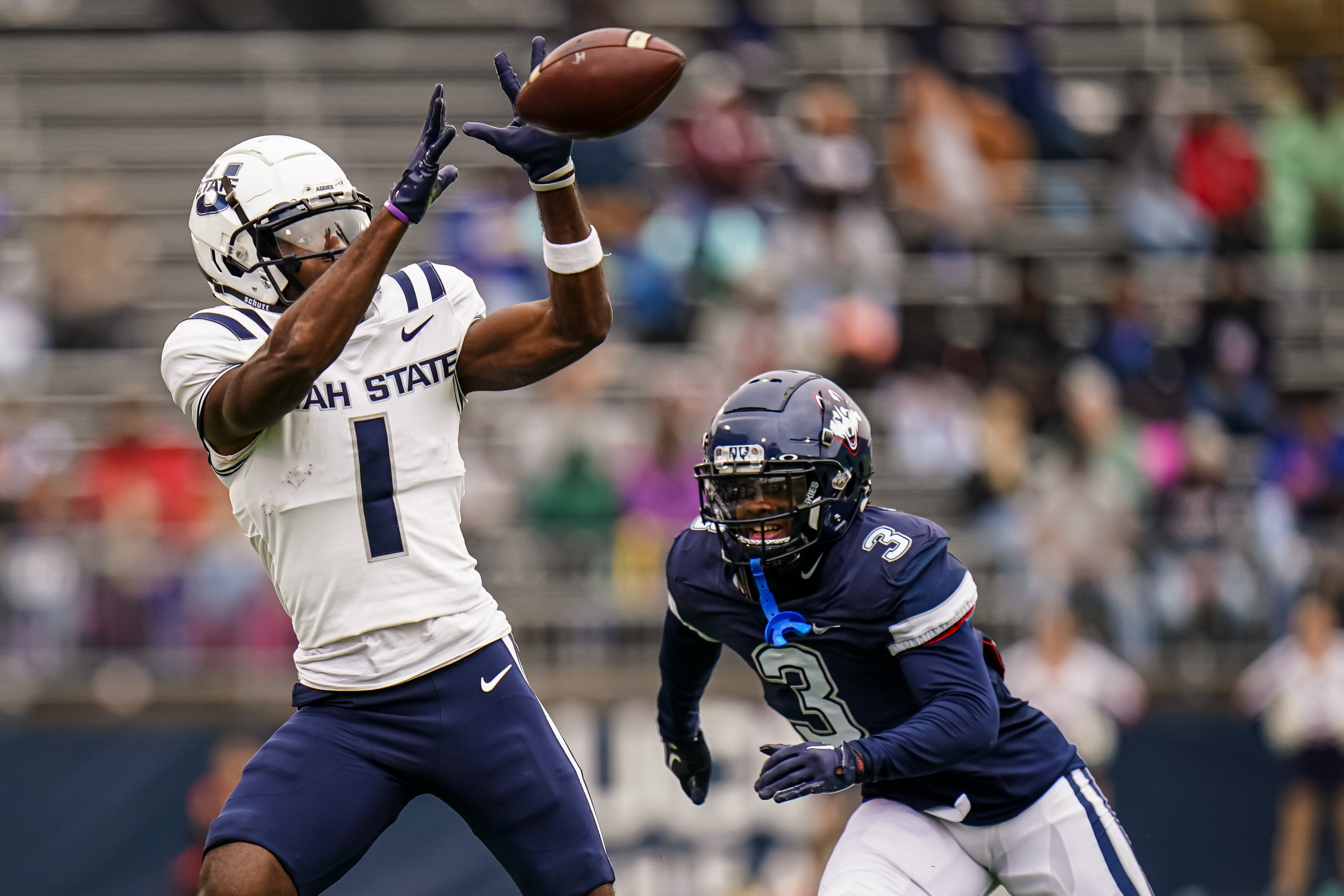 Utah State Aggies wide receiver Jalen Royals (1) makes the catch against UConn Huskies defensive back D'Mon Brinson (3)