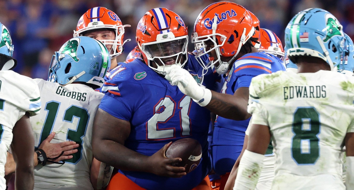 Dec 20, 2024; Tampa, FL, USA; Florida Gators defensive lineman Desmond Watson (21) runs the ball for a first down against the Tulane Green Wave during the second half at Raymond James Stadium.