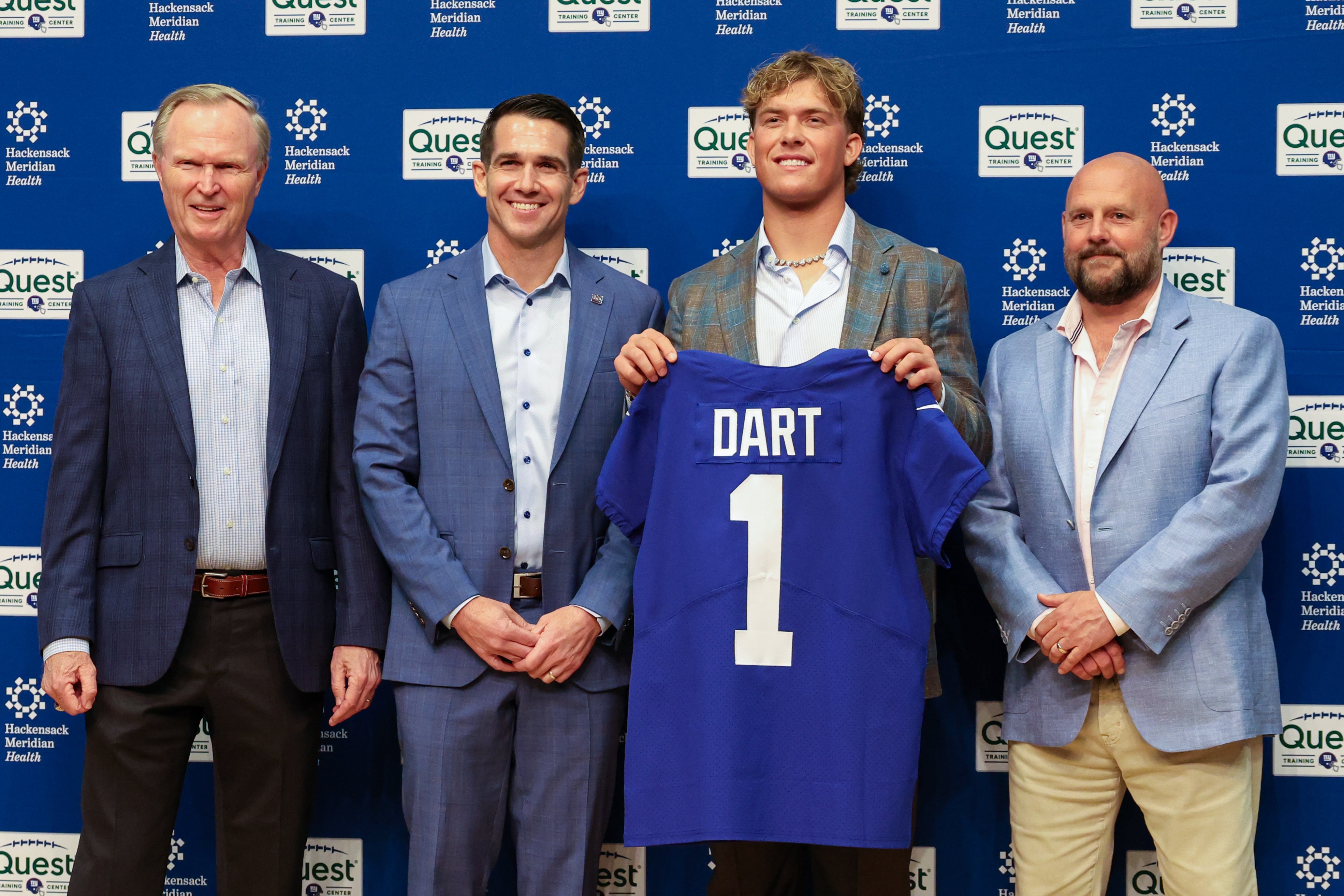 Apr 25, 2025; East Rutherford, NJ, US; New York Giants president John Mara (far left), general manager Joe Schoen (left), Jaxson Dart, and head coach Brian Daboll (right) pose for photos prior to the start of the press conference to introduce the Giants first round draft picks.