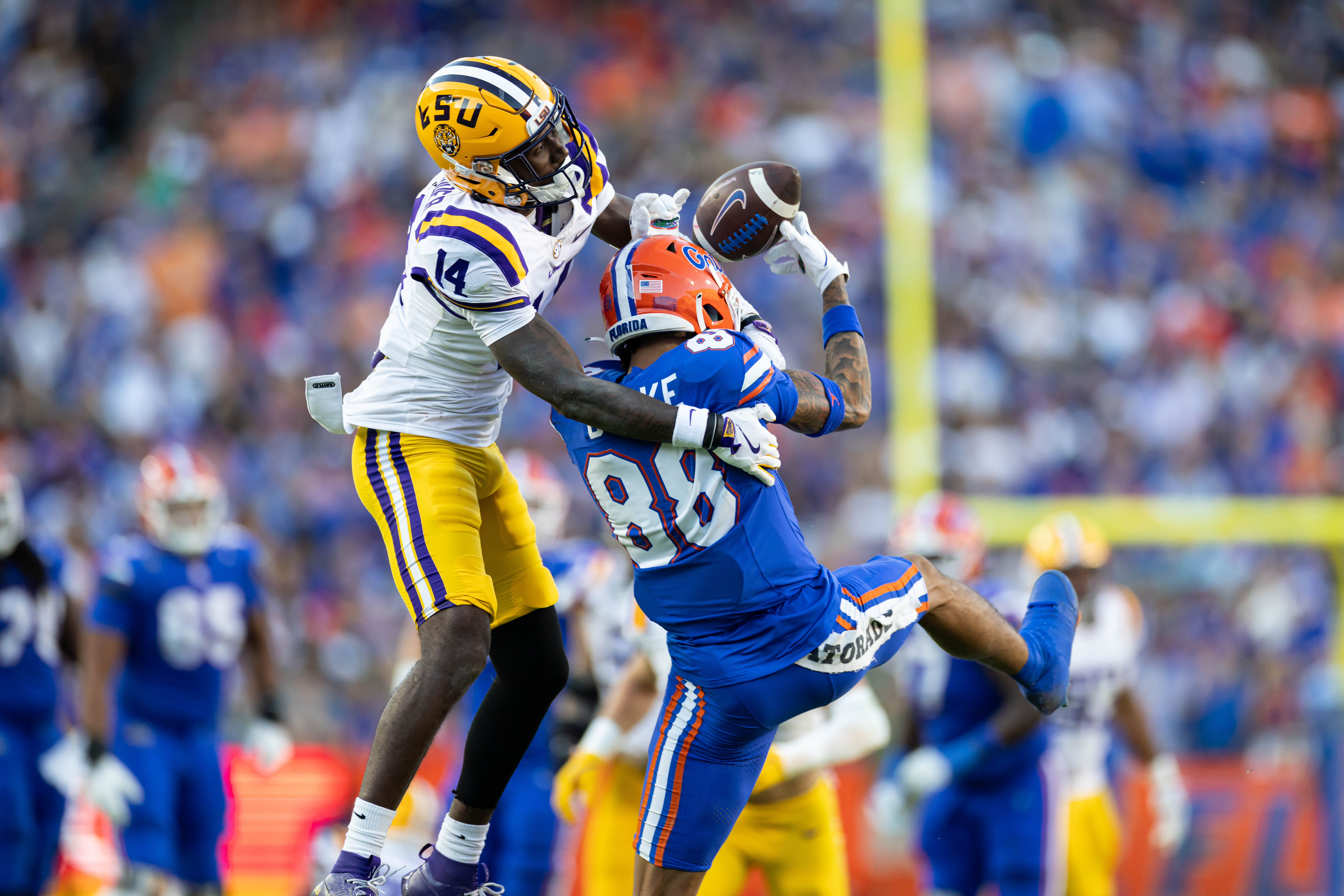 Nov 16, 2024; Gainesville, Florida, USA; LSU Tigers cornerback Zy Alexander (14) breaks up a pass to Florida Gators wide receiver Marcus Burke (88) during the first half at Ben Hill Griffin Stadium.