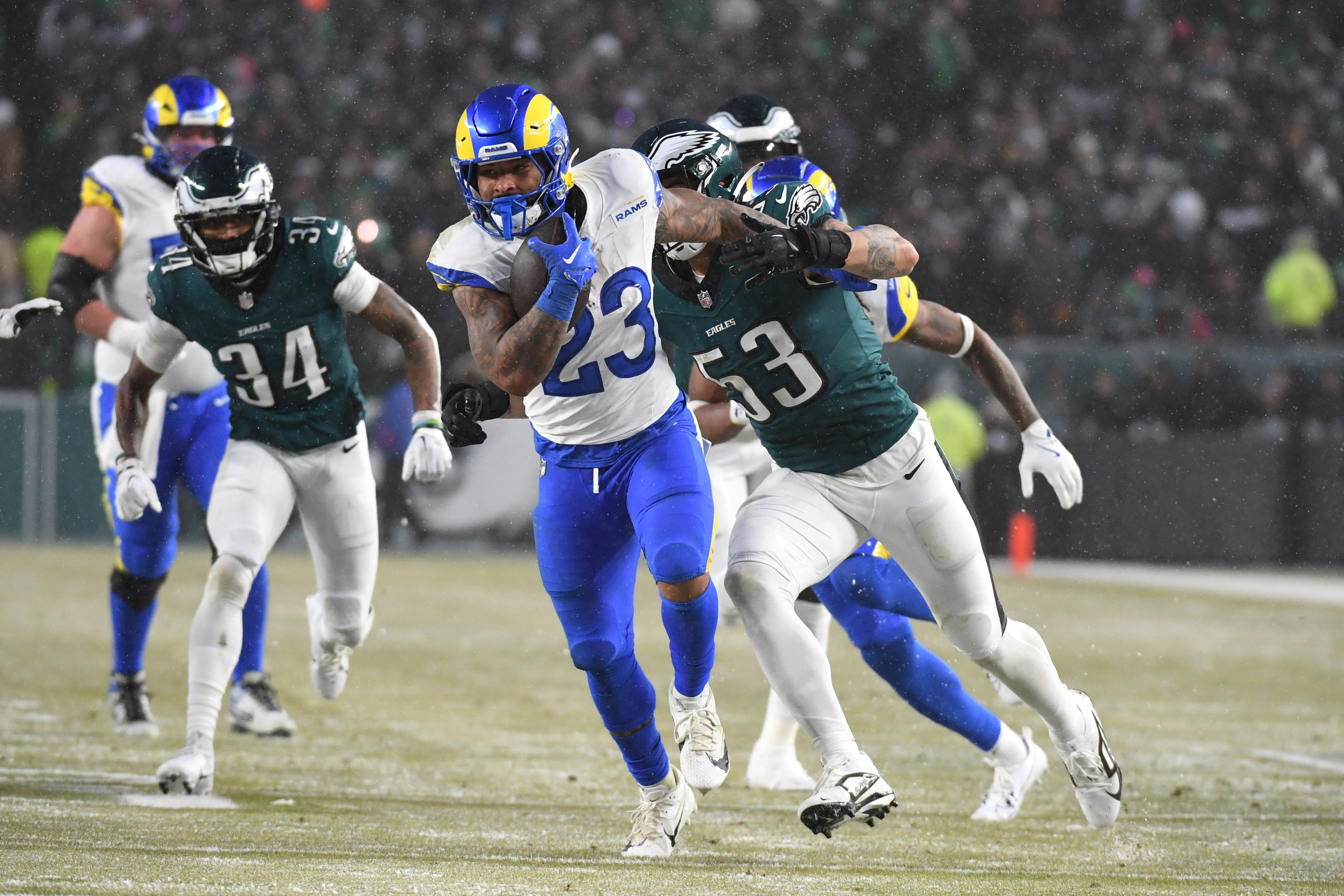 Jan 19, 2025; Philadelphia, Pennsylvania, USA; Los Angeles Rams running back Kyren Williams (23) runs past Philadelphia Eagles linebacker Zack Baun (53) during the third quarter against the Philadelphia Eagles in a 2025 NFC divisional round game at Lincoln Financial Field