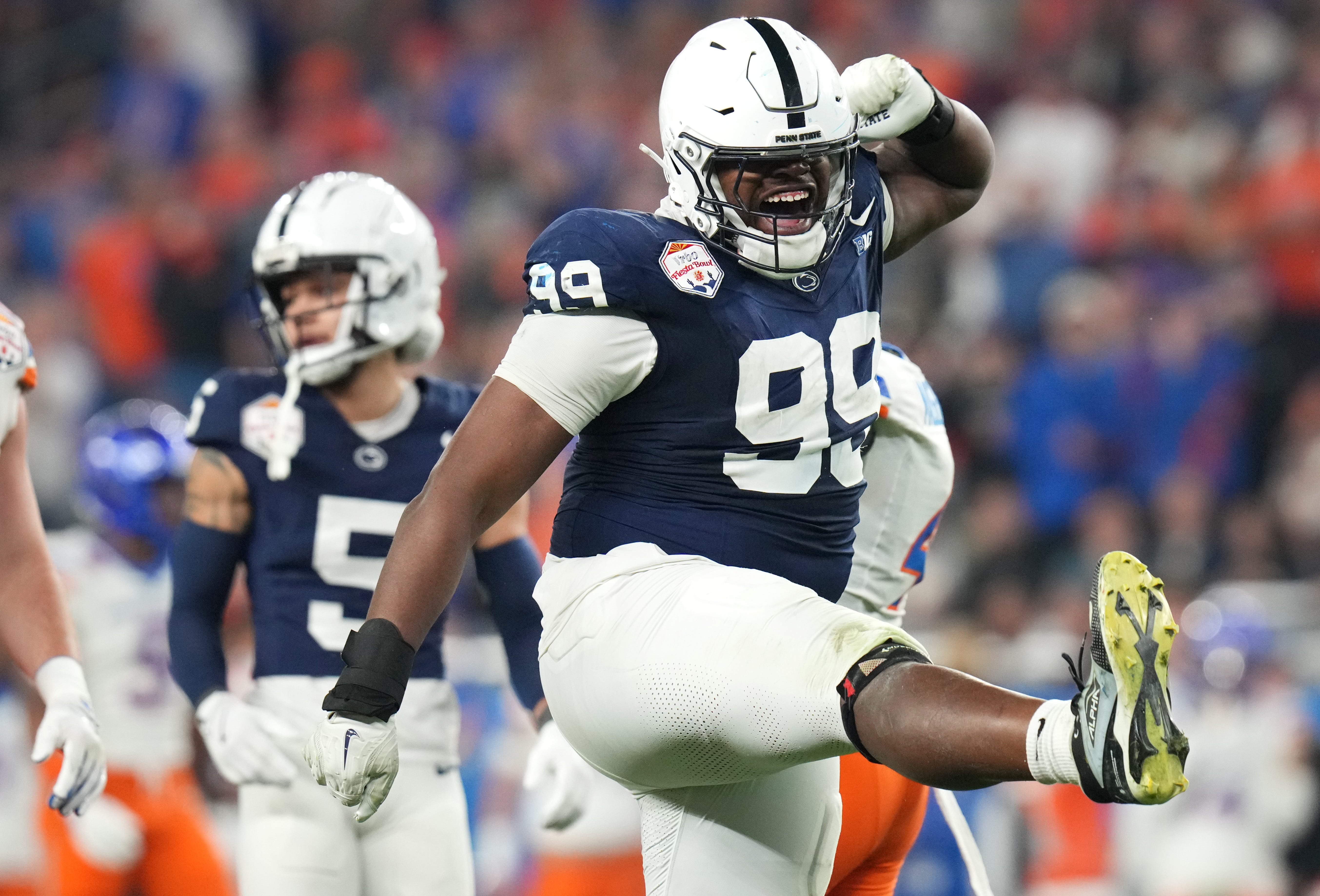 Dec 31, 2024; Glendale, AZ, US; Penn State Nittany Lions defensive tackle Coziah Izzard (99) celebrates a defensive stop against the Boise State Broncos during their Vrbo Fiesta Bowl matchup at State Farm Stadium.