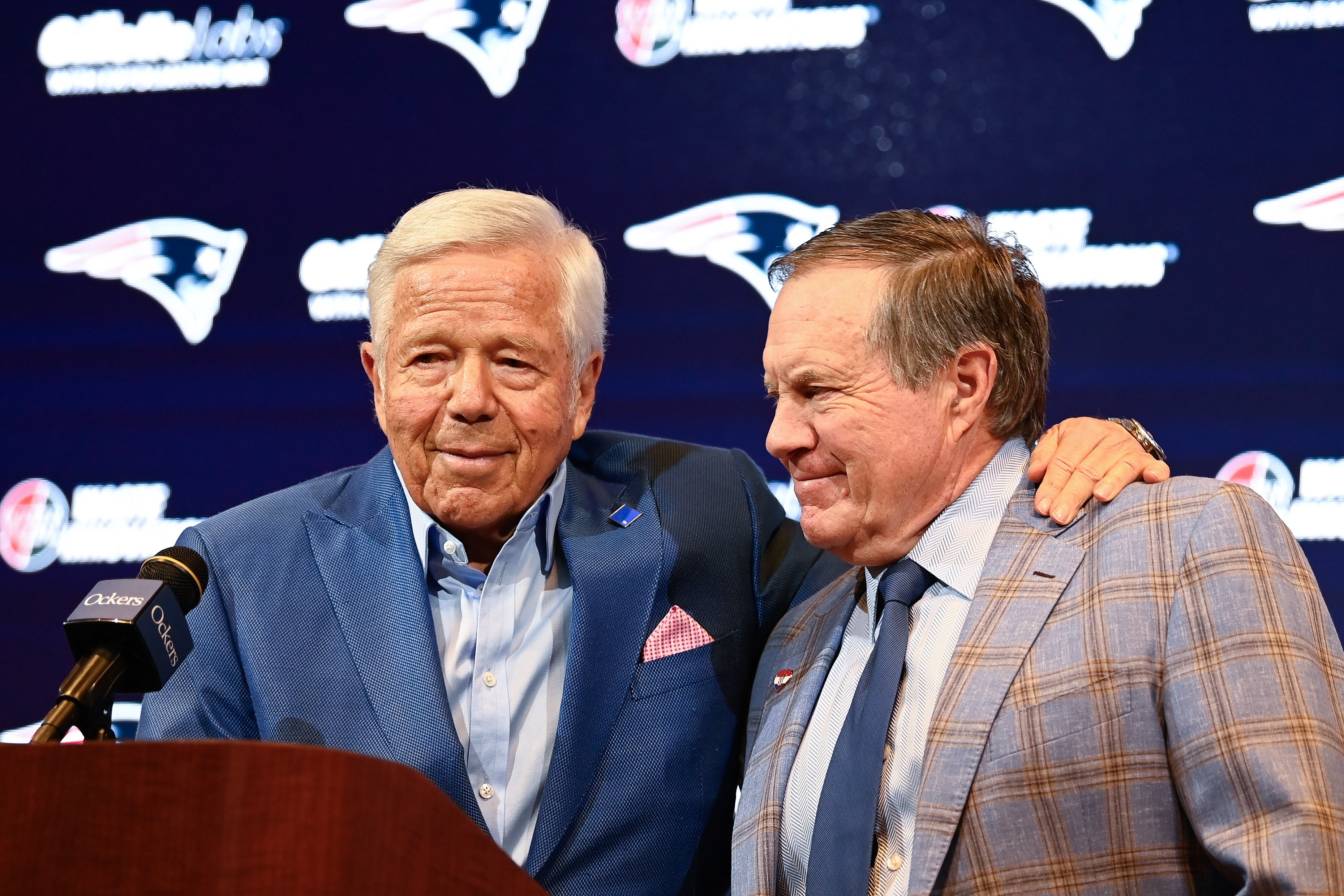 Jan 11, 2024; Foxborough, MA, USA; New England Patriots former head coach Bill Belichick (right) embraces Patriots owner Robert Kraft (left) during a press conference at Gillette Stadium to announce Belichick's exit from the team.