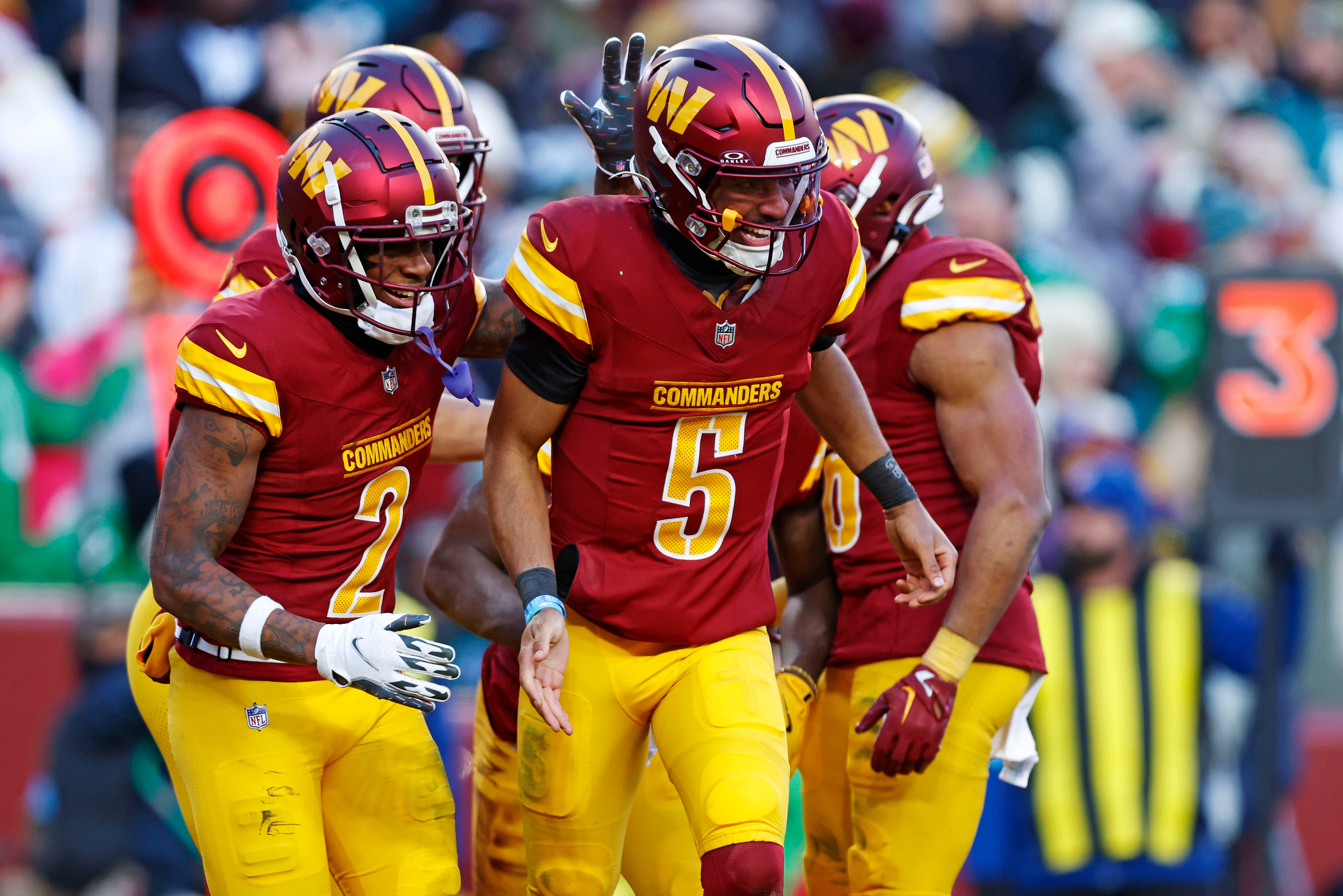 Dec 22, 2024; Landover, Maryland, USA; Washington Commanders quarterback Jayden Daniels (5) celebrates after throwing a touchdown pass during the fourth quarter against the Philadelphia Eagles at Northwest Stadium.