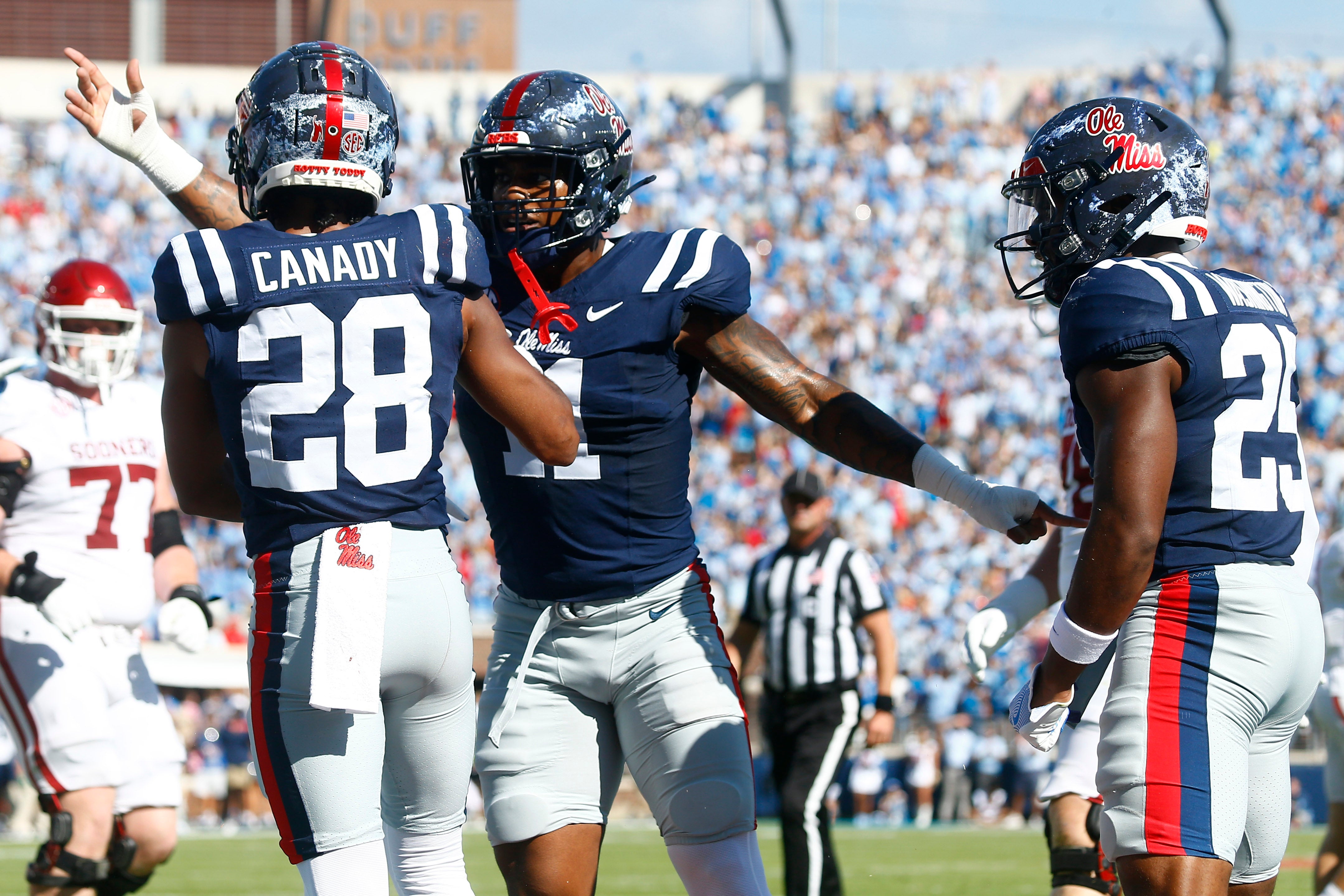 Oct 26, 2024; Oxford, Mississippi, USA; Mississippi Rebels linebacker Chris Paul Jr. (11) reacts with defensive back Jadon Canady (28) after a fourth down stop during the first half against the Oklahoma Sooners at Vaught-Hemingway Stadium. Mandatory Credit: Petre Thomas-Imagn Images