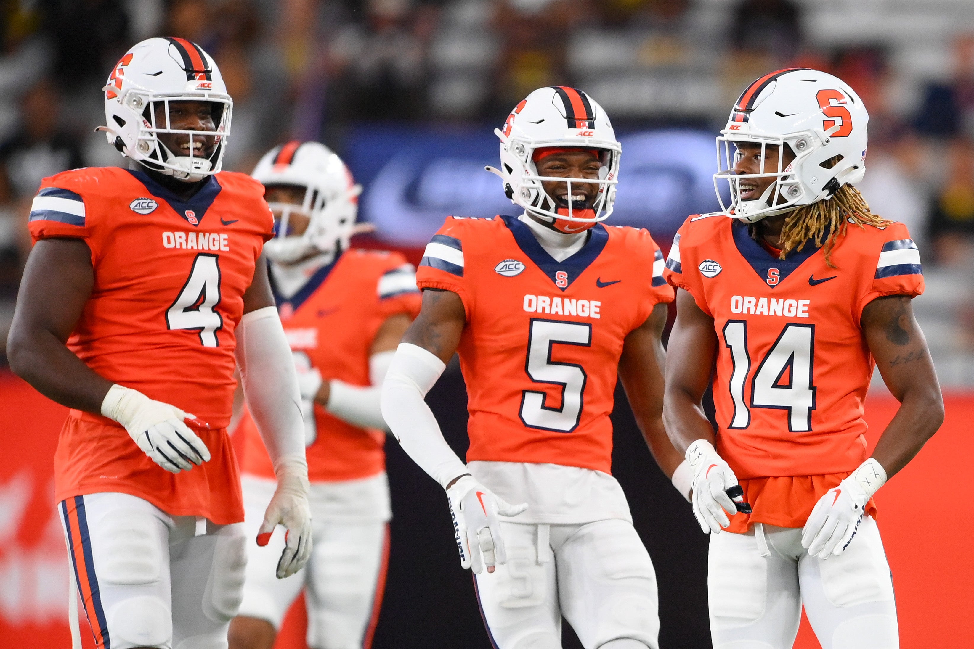 Syracuse Orange defensive lineman Caleb Okechukwu (4) and defensive back Alijah Clark (5) and defensive back Jason Simmons Jr. (14) reacts to a play against the Western Michigan Broncos during the second half at the JMA Wireless Dome.