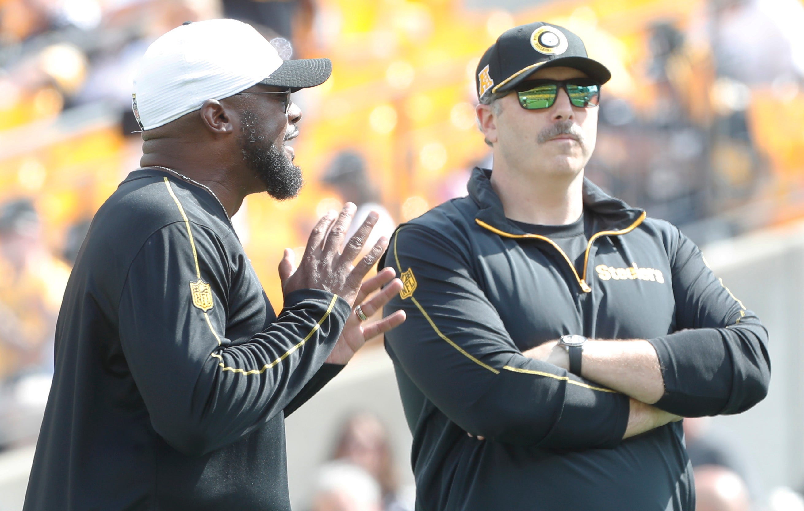 Sep 22, 2024; Pittsburgh, Pennsylvania, USA; Pittsburgh Steelers head coach Mike Tomlin (left) and offensive coordinator Arthur Smith (right) talk on the field before the game against the Los Angeles Chargers at Acrisure Stadium.