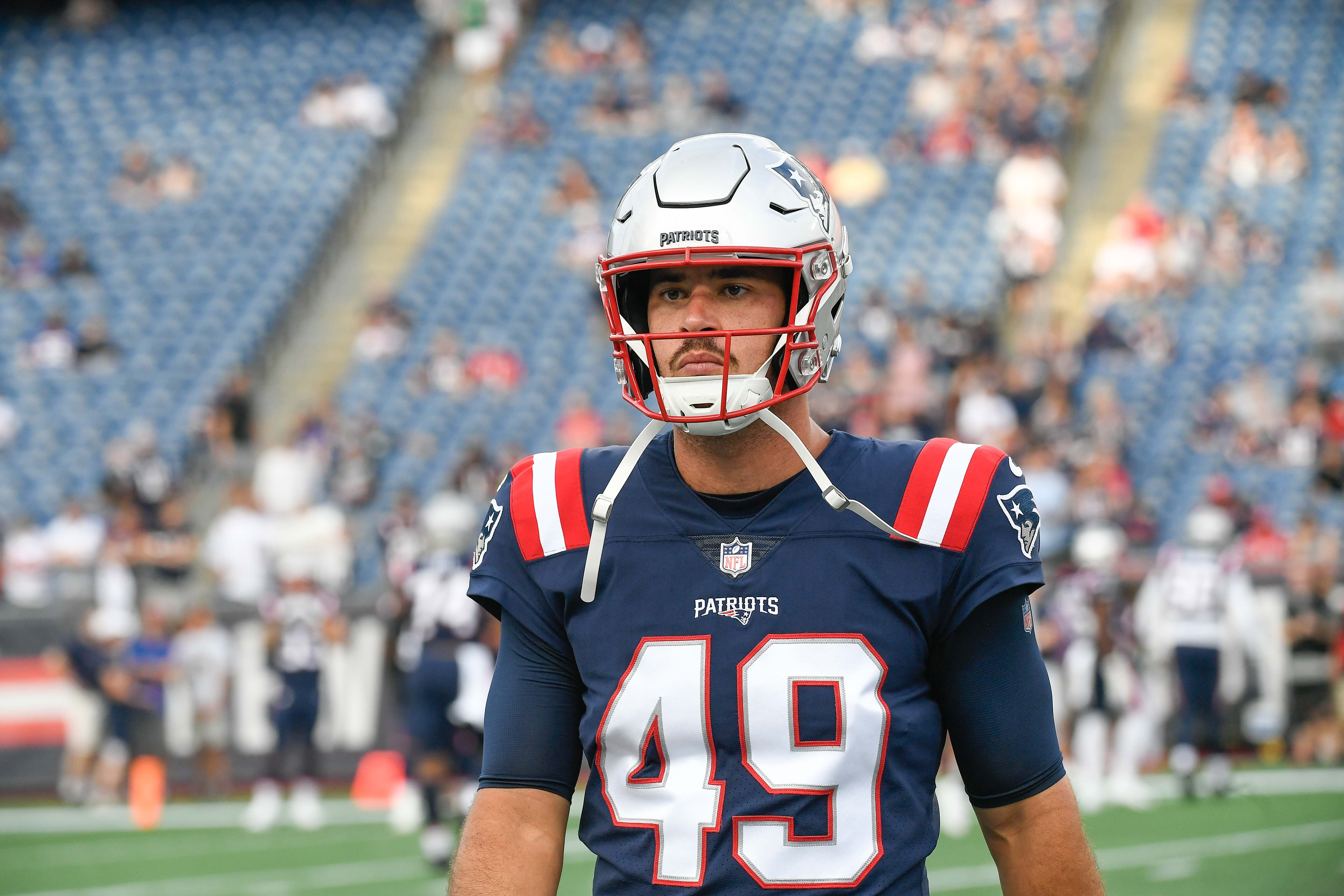 Aug 11, 2022; Foxborough, Massachusetts, USA; New England Patriots long snapper Joe Cardona (49) warms up before a preseason game against the New York Giants at Gillette Stadium.