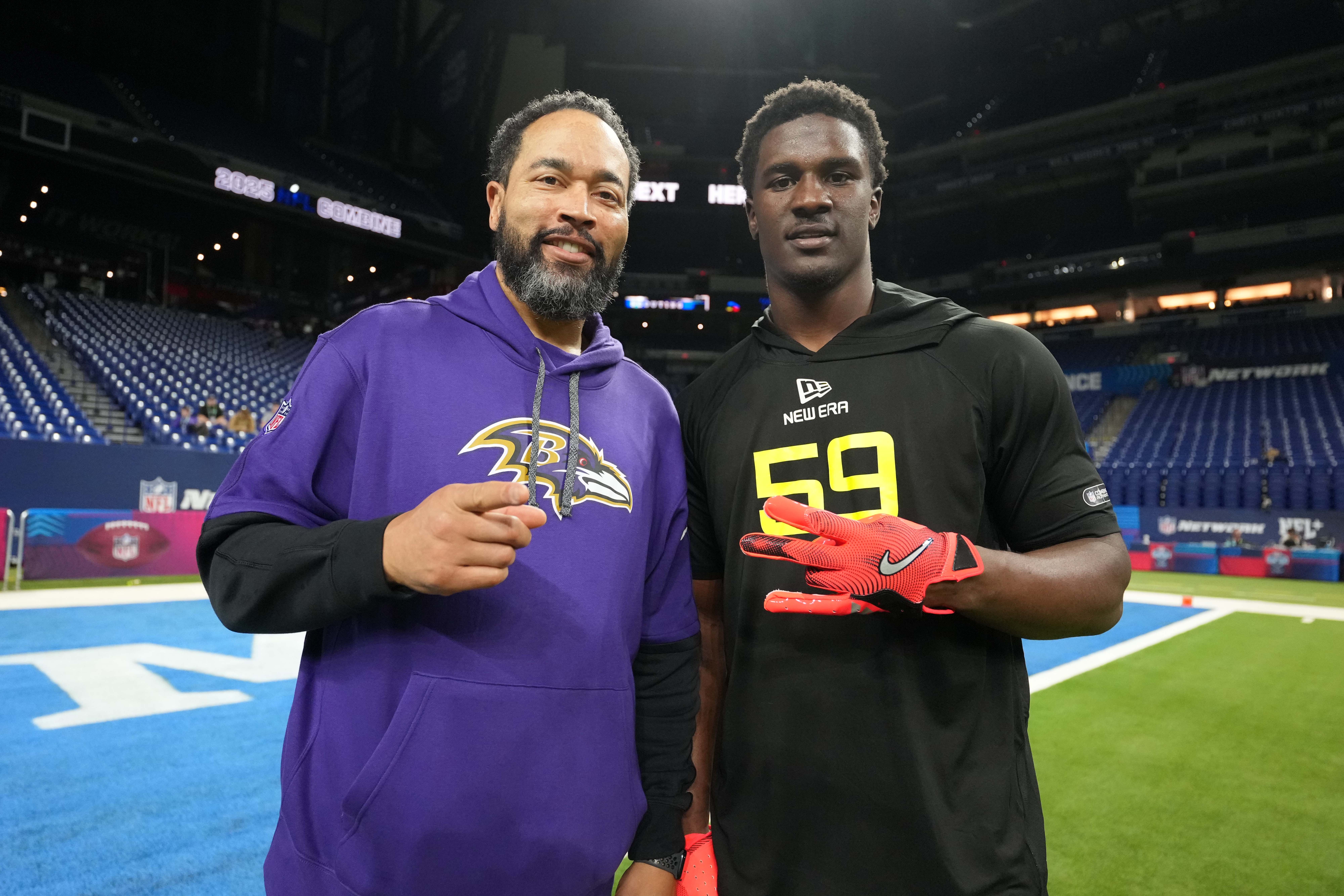 Feb 27, 2025; Indianapolis, IN, USA; Baltimore Ravens pass rush coach Chuck Smith (left) poses with Tennessee defensive lineman James Pearce (DL59) during the 2025 NFL Combine at Lucas Oil Stadium.