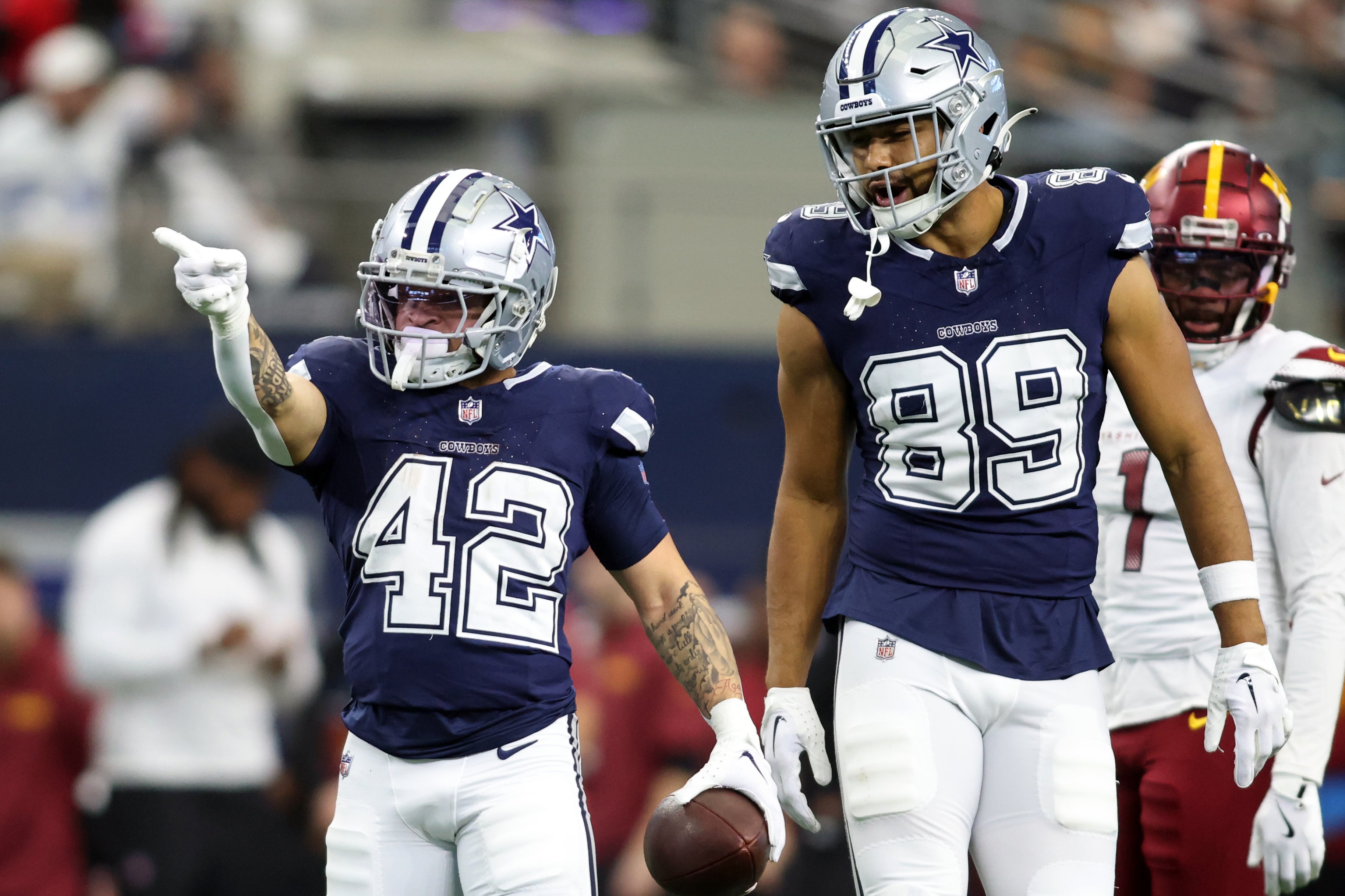 Dallas Cowboys running back Deuce Vaughn (42) reacts after getting a first down against the Washington Commanders during the fourth quarter at AT&T Stadium.