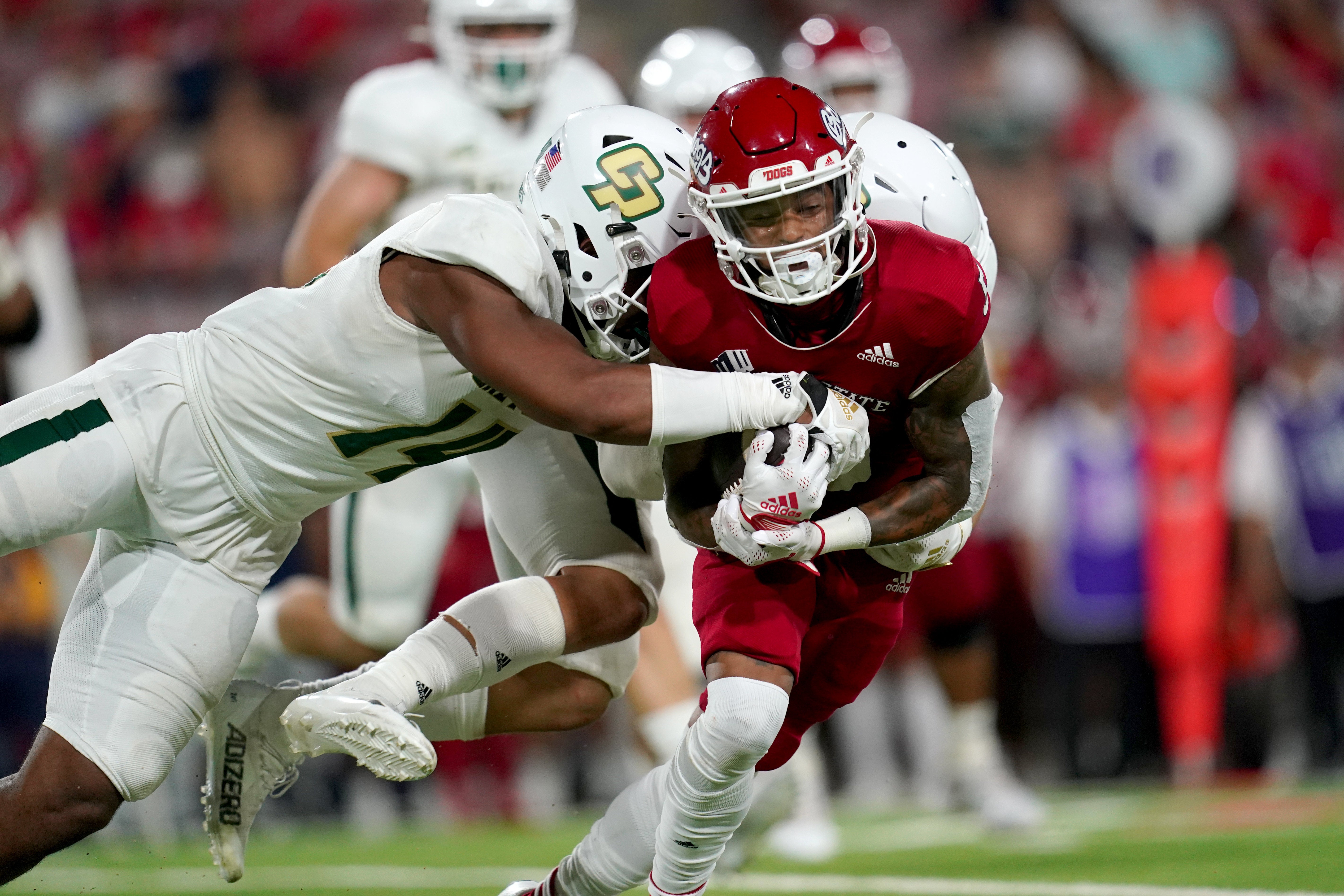 Fresno State Bulldogs wide receiver Jalen Moreno-Cropper (5) is tackled by Cal Poly Mustangs defensive lineman Elijah Ponder (14) after making a catch in the third quarter at Valley Children's Stadium.
