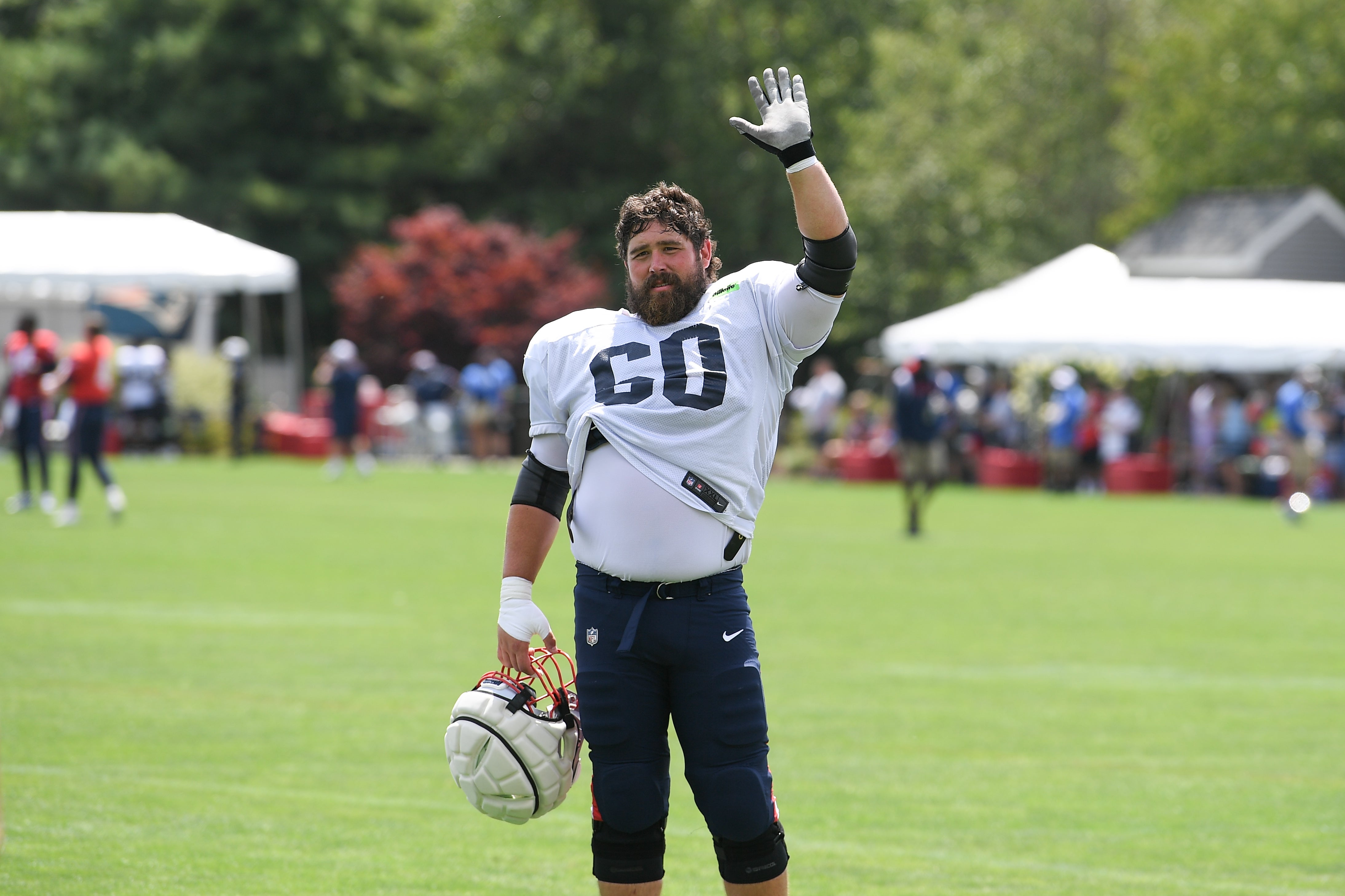 Aug 03, 2024; Foxborough, MA, USA; New England Patriots center David Andrews (60) waves to his son at training camp at Gillette Stadium.